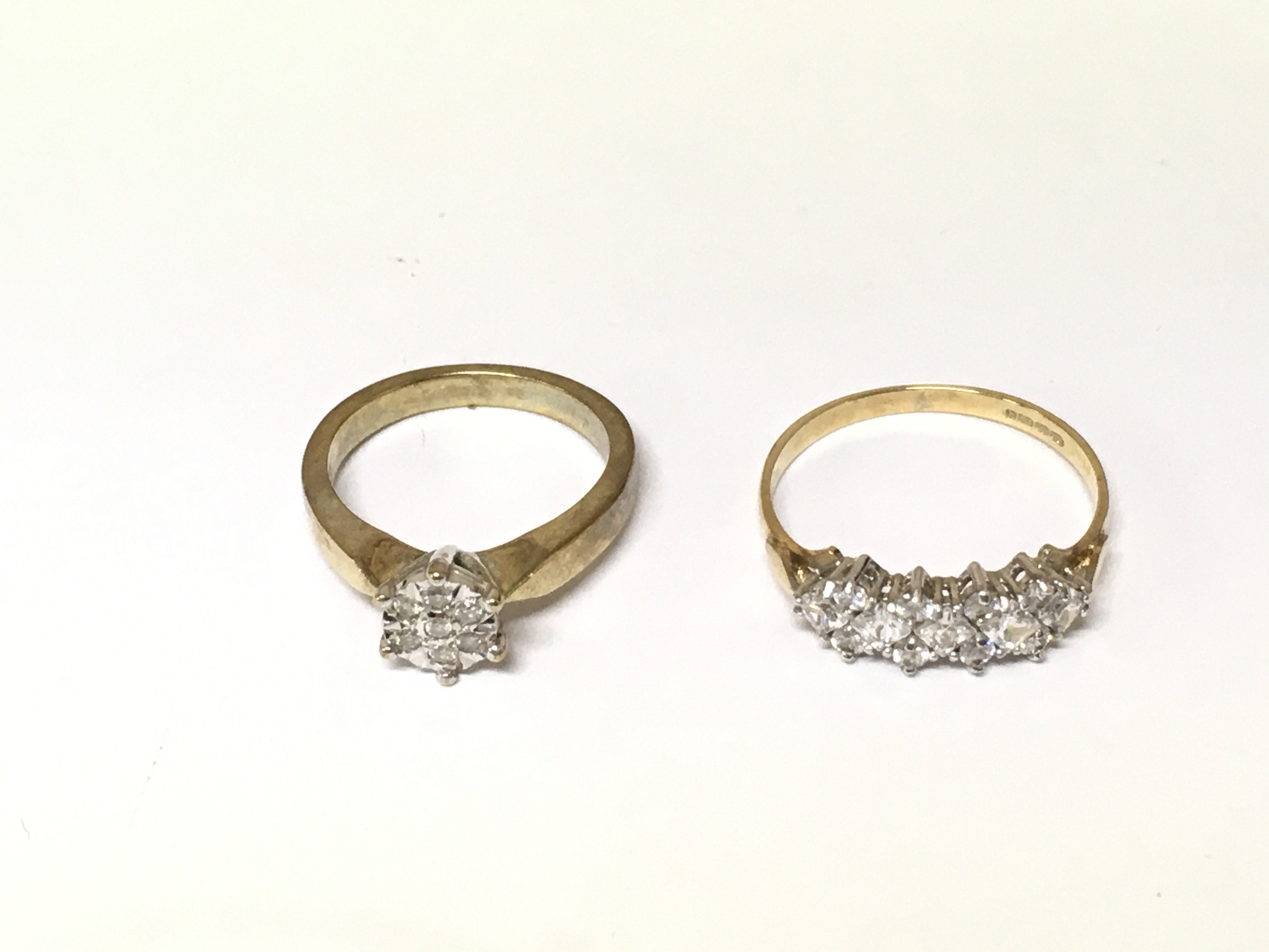 A 9ct diamond cluster ring size L and a 9ct gold CZ set ring size R. Total weight 5.41g