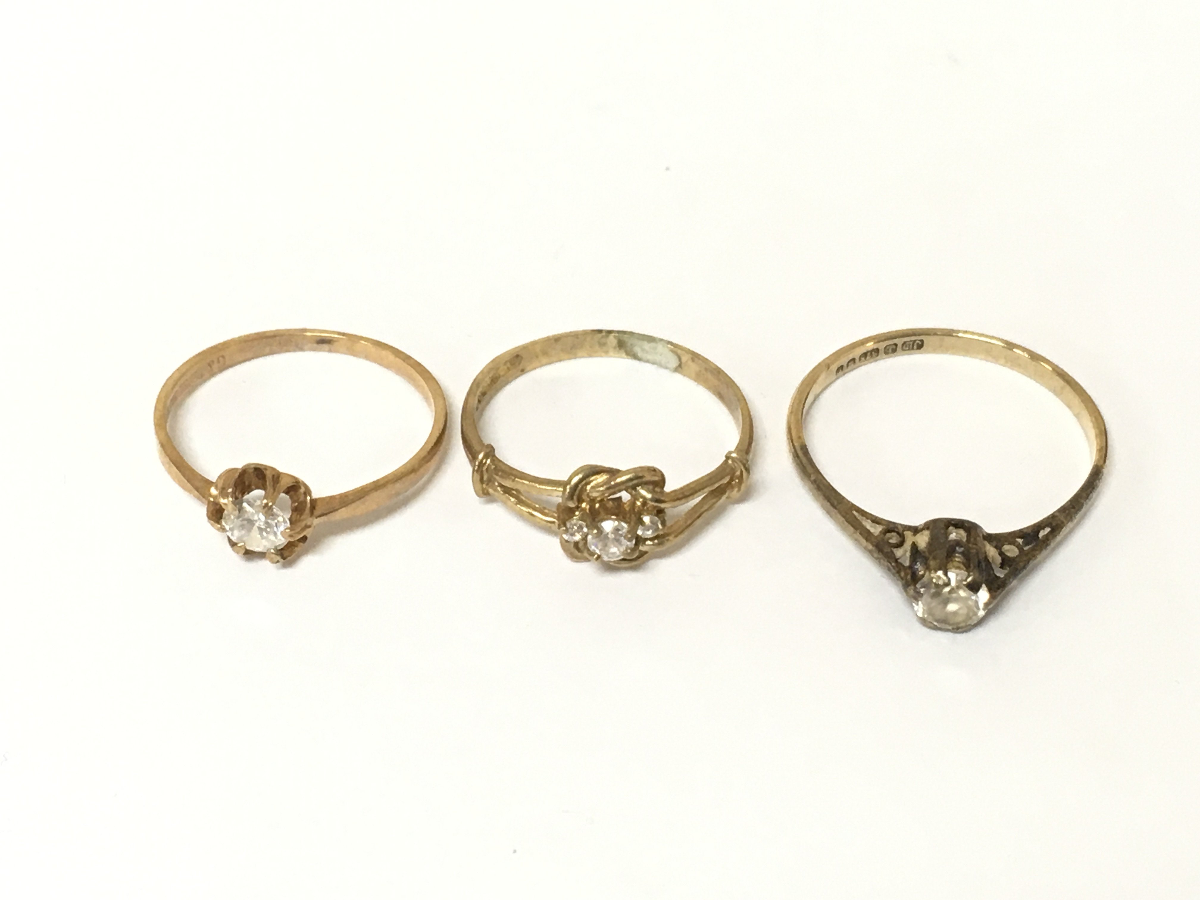 Three 9ct gold rings set with white stones. Approximately 4g. Sizes L and P
