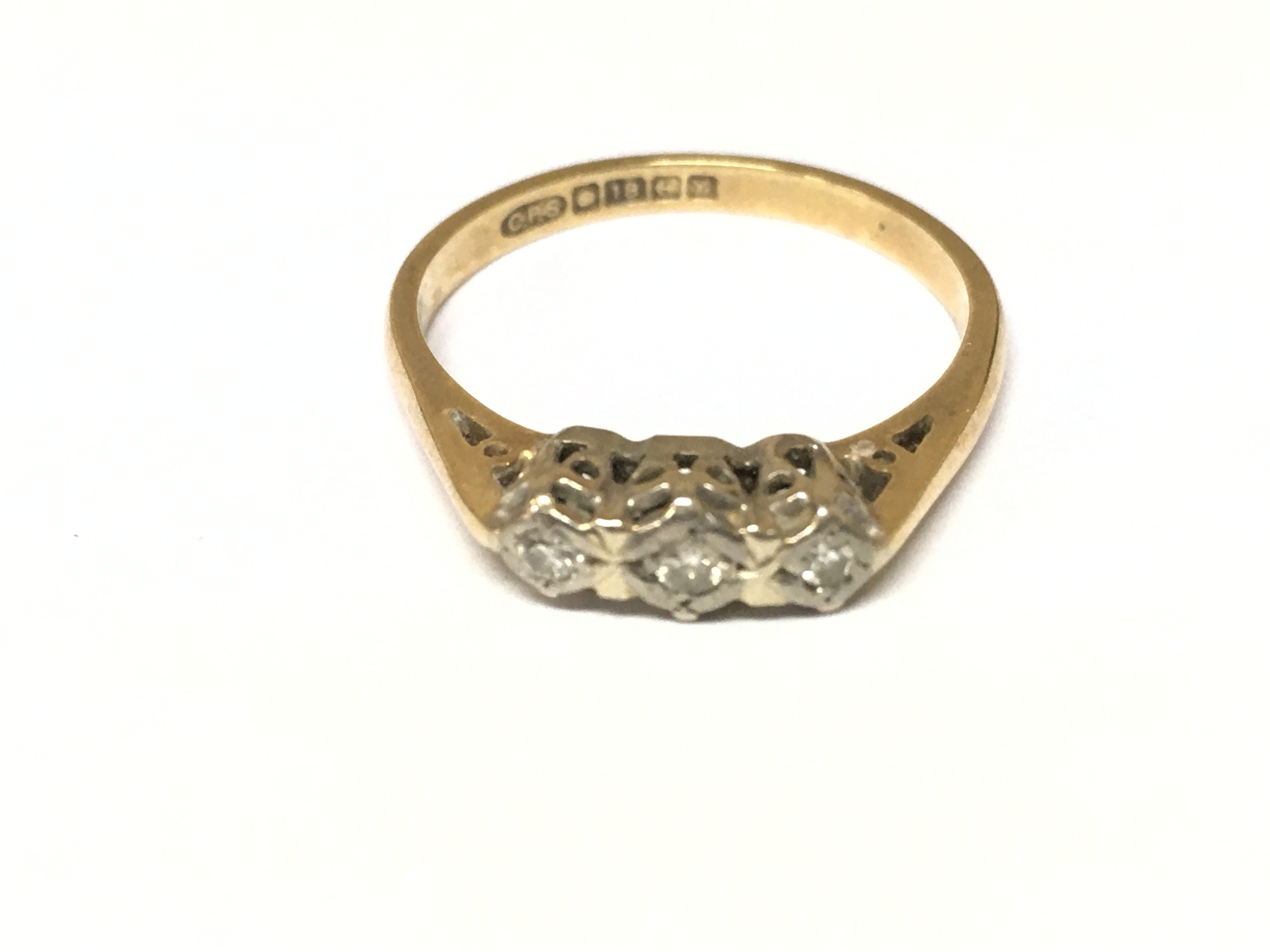 An 18ct gold ring set with small diamonds. 2.71g size N Postage A