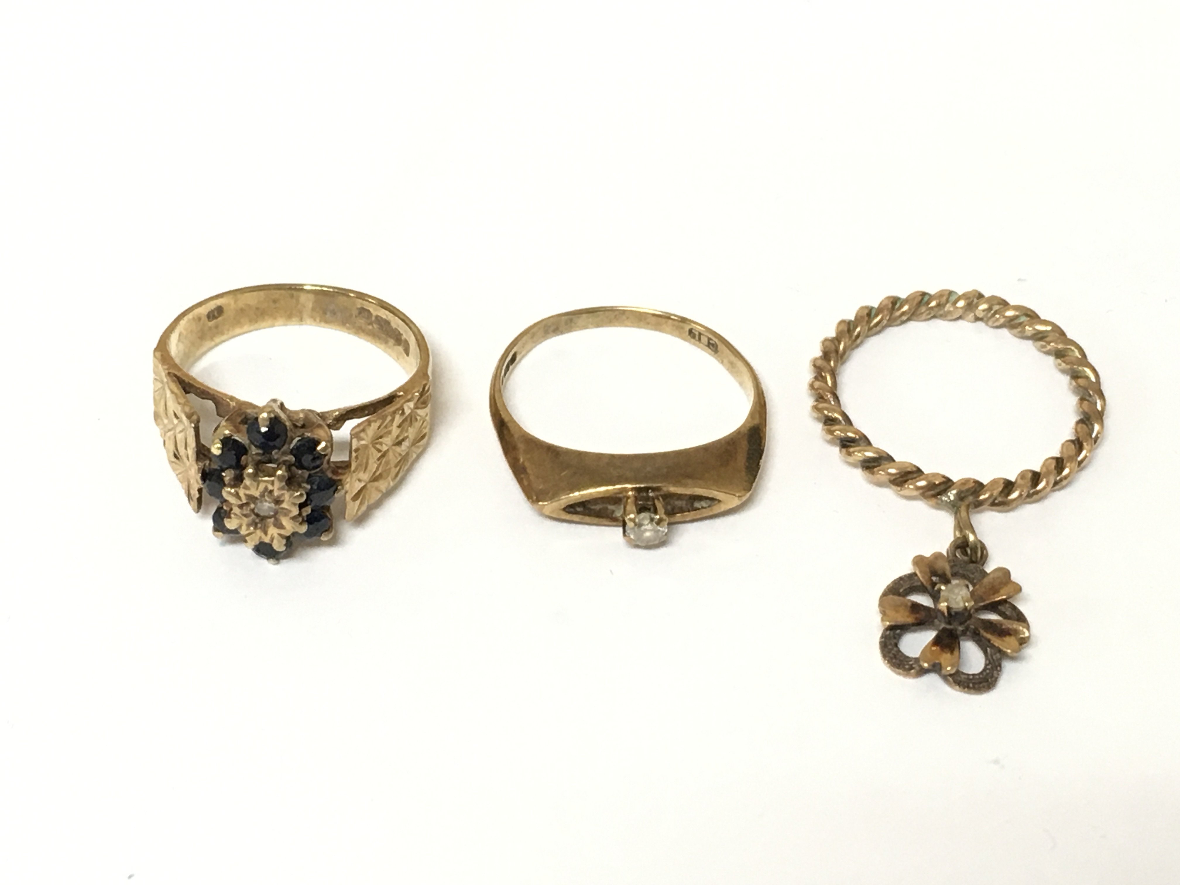 Three 9ct gold rings set various designs. Sizes H and I approximately 6.14g