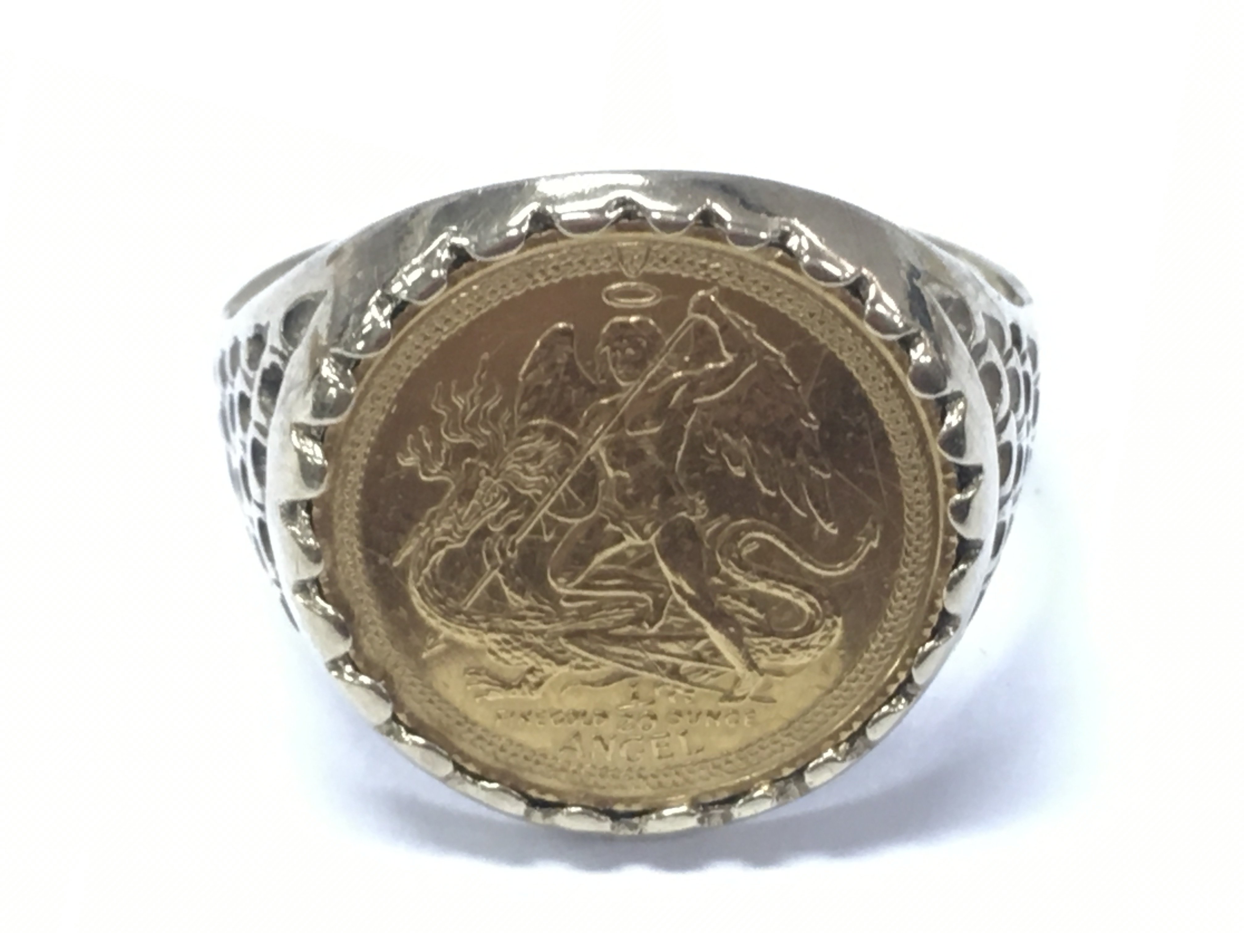 A St Micheal Fine Gold 22ct 1/20 ounce coin mounted in a 9 carat gold ring. 4.2g total weight . Postage category A