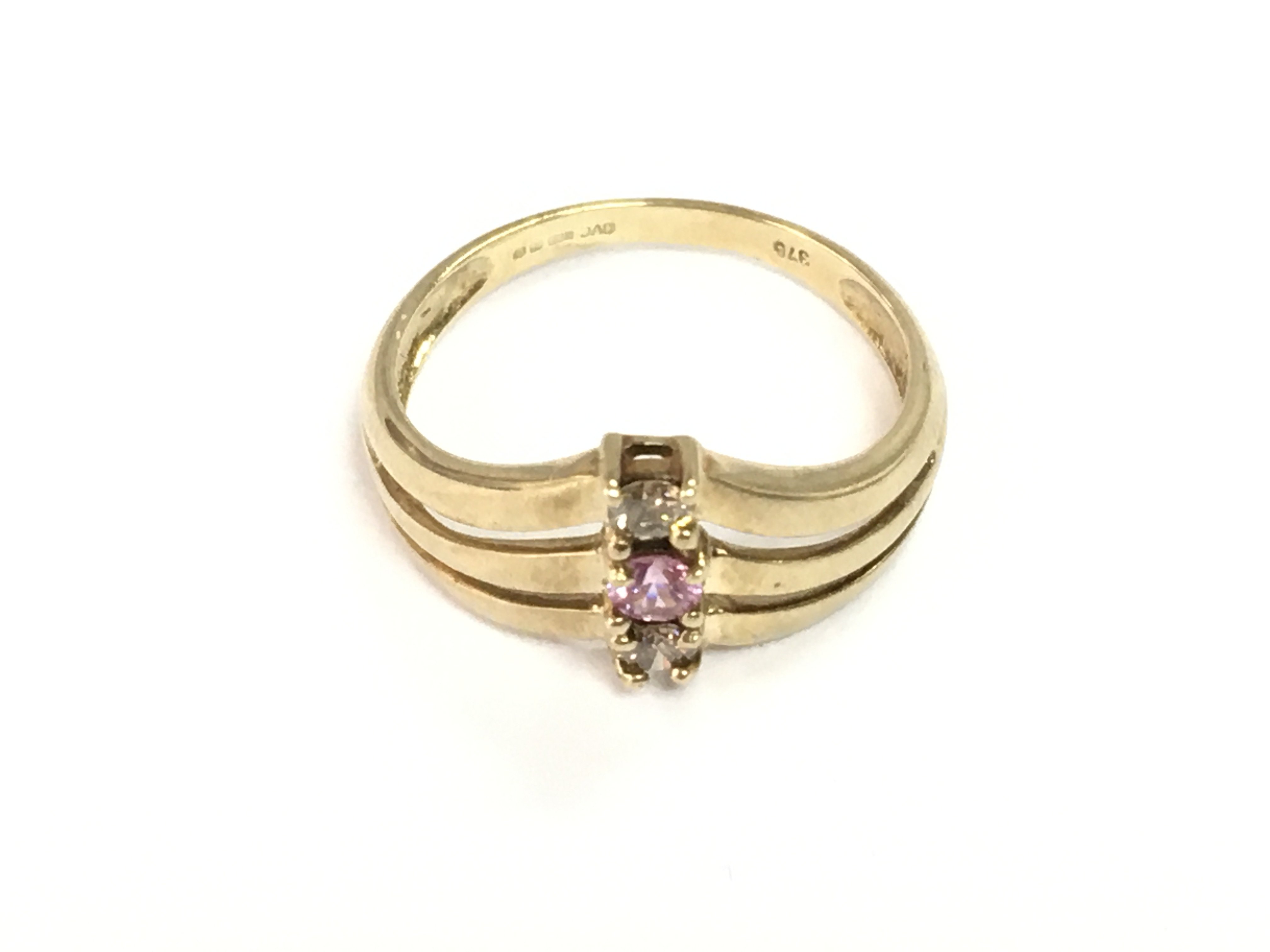 A 9ct yellow gold triple wishbone ring set with a pink sapphire and diamonds. Sapphire 0.12ct and diamonds 0.18ct. Size size O 1/2