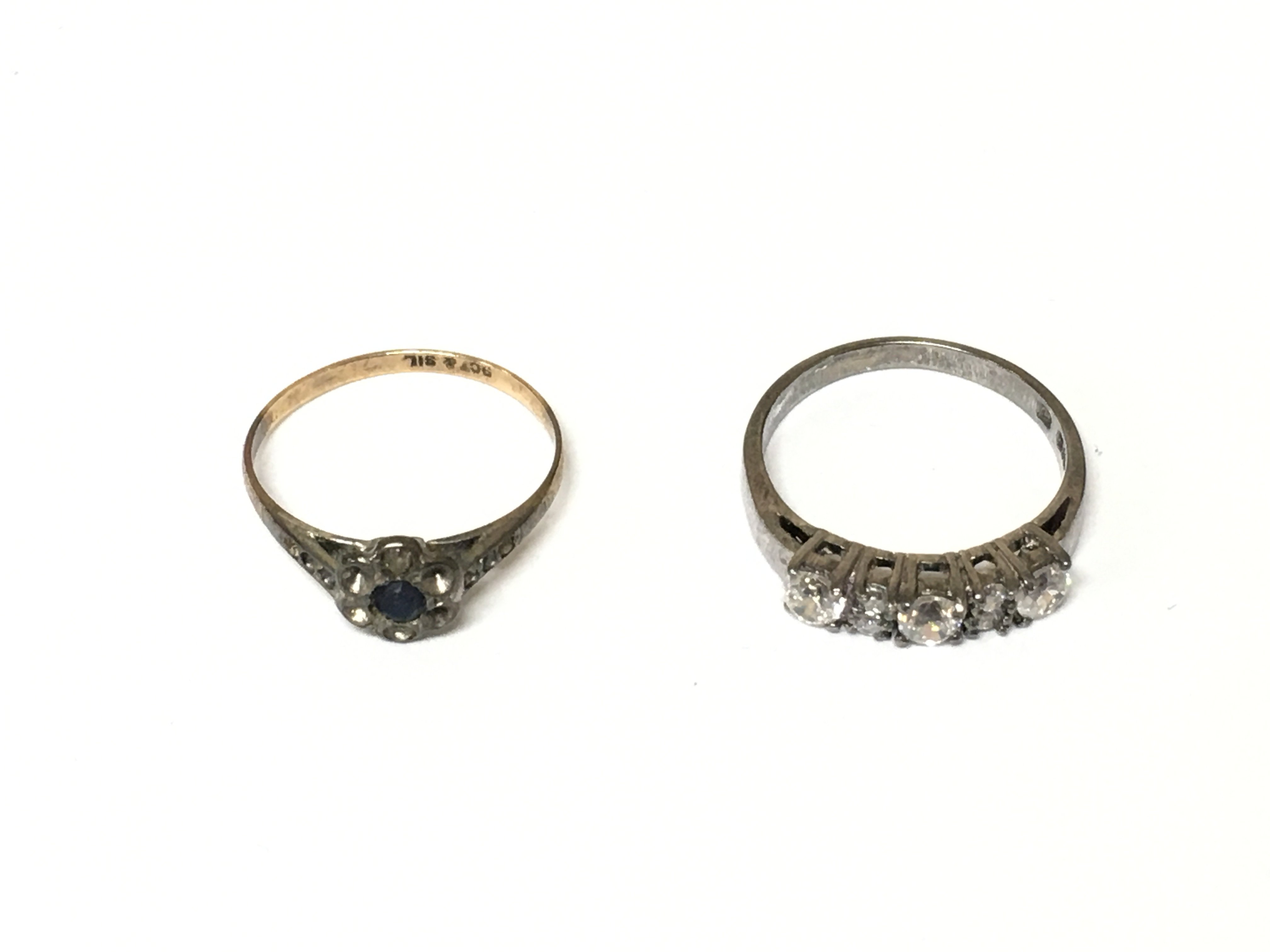 A 9ct gold and silver ring 1.14g and a silver ring both set with CZ. Size N and N 1/2