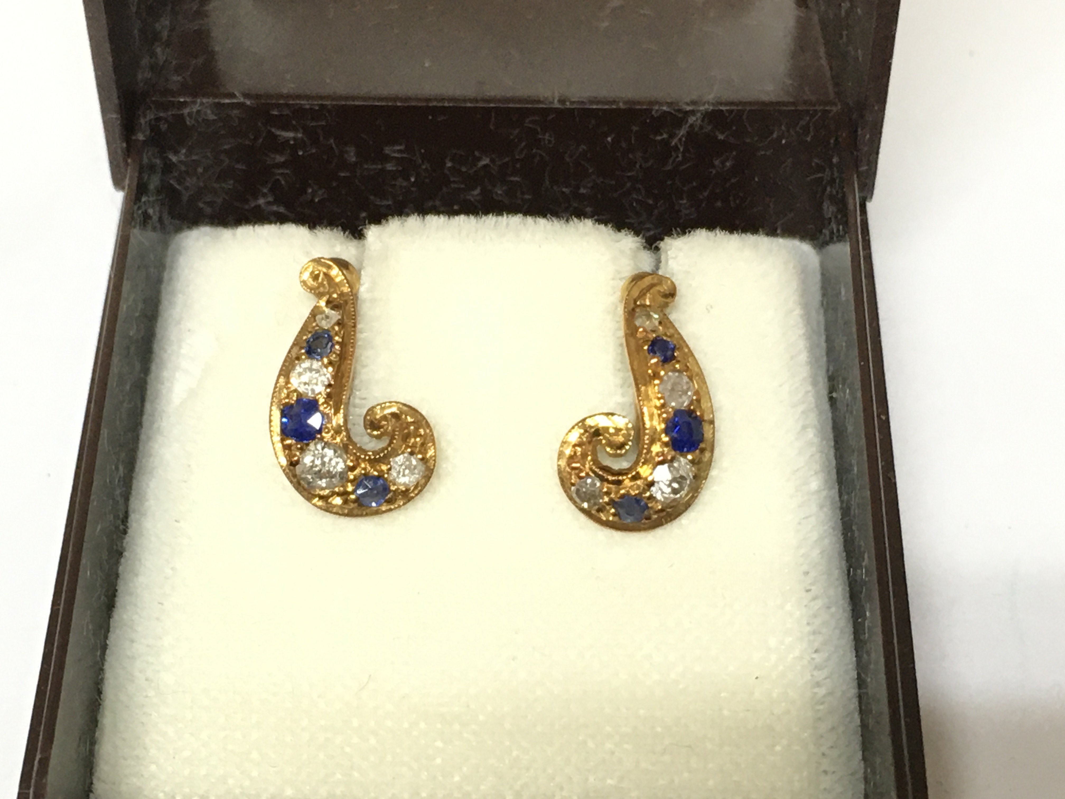 An 18ct gold pair of sapphire and diamond screw back earrings. Postage B
