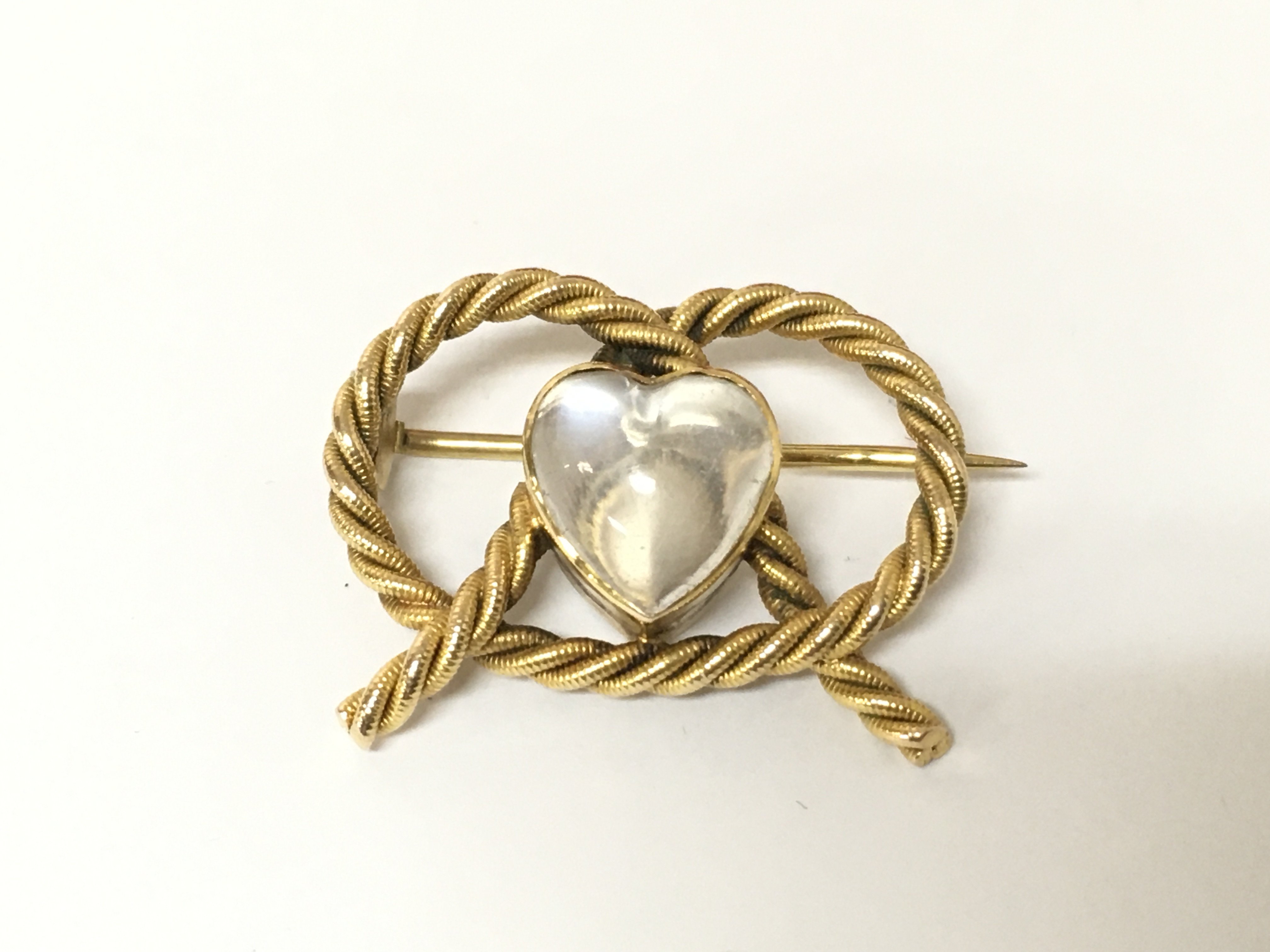 A 9ct gold lovers knot with moonstone. 5.09g