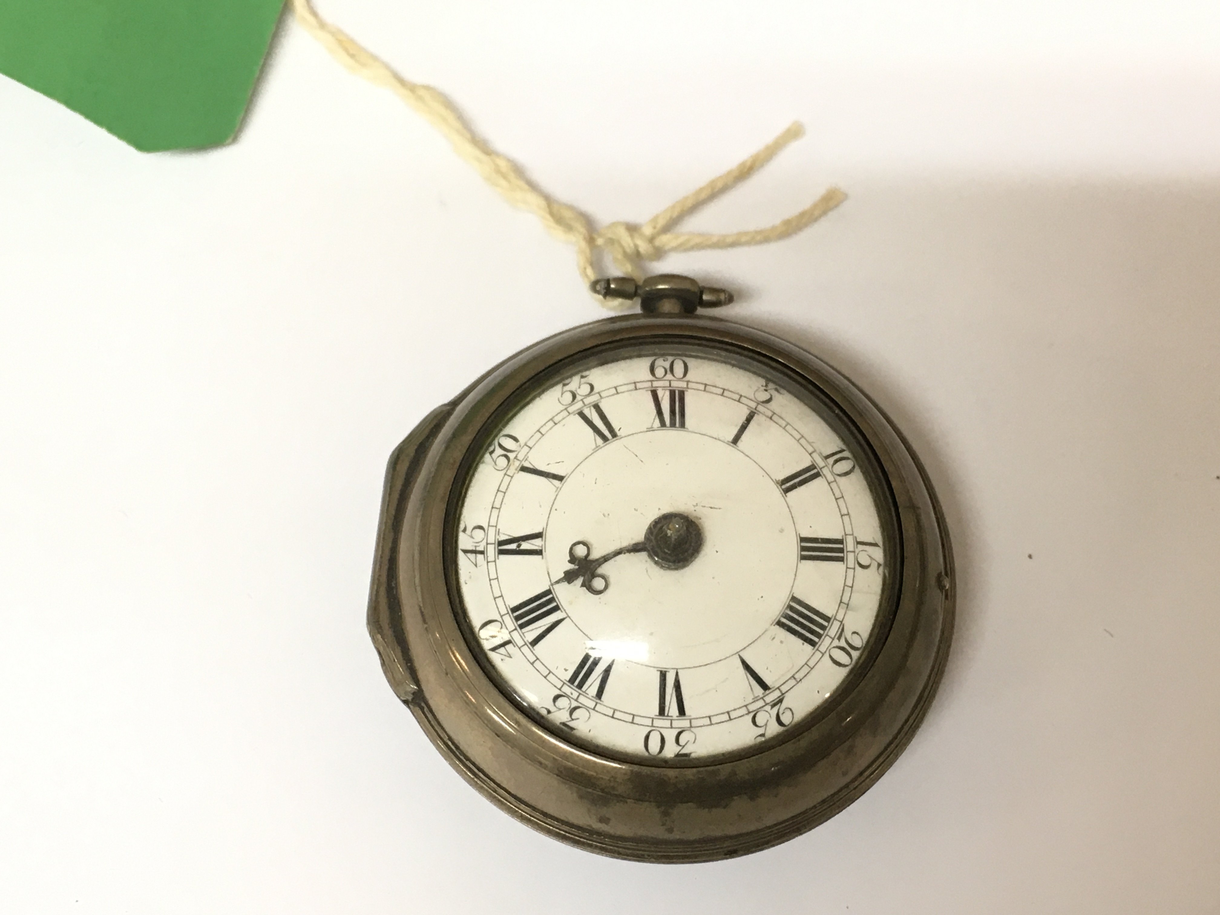 A hallmarked silver pair cased pocket watch in need of repair, circa 1763