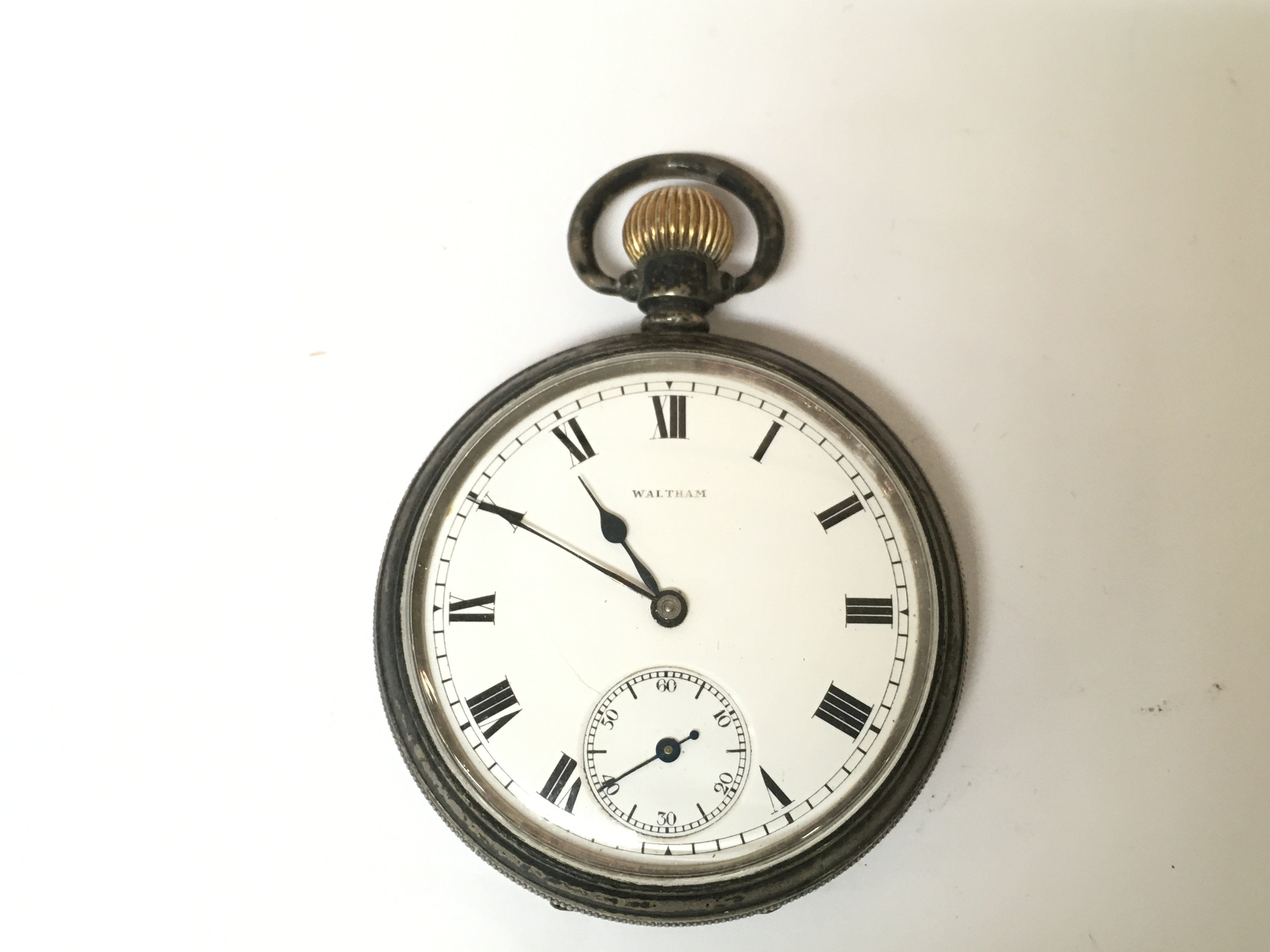 A silver hallmarked Waltham pocket watch. 99g winds and runs.