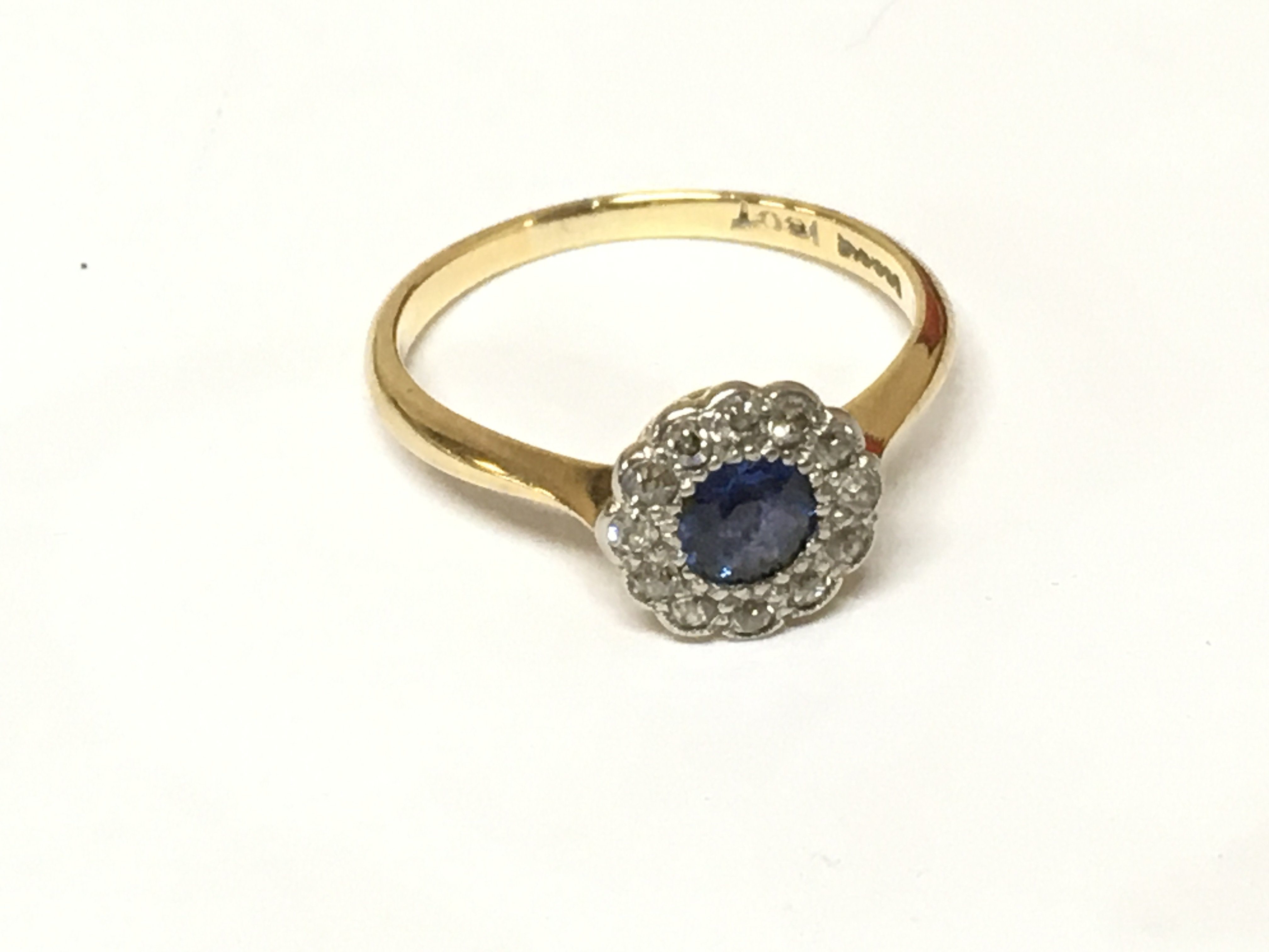 An 18ct gold and platinum cornflower blue sapphire and diamond ring. 2.63g size O
