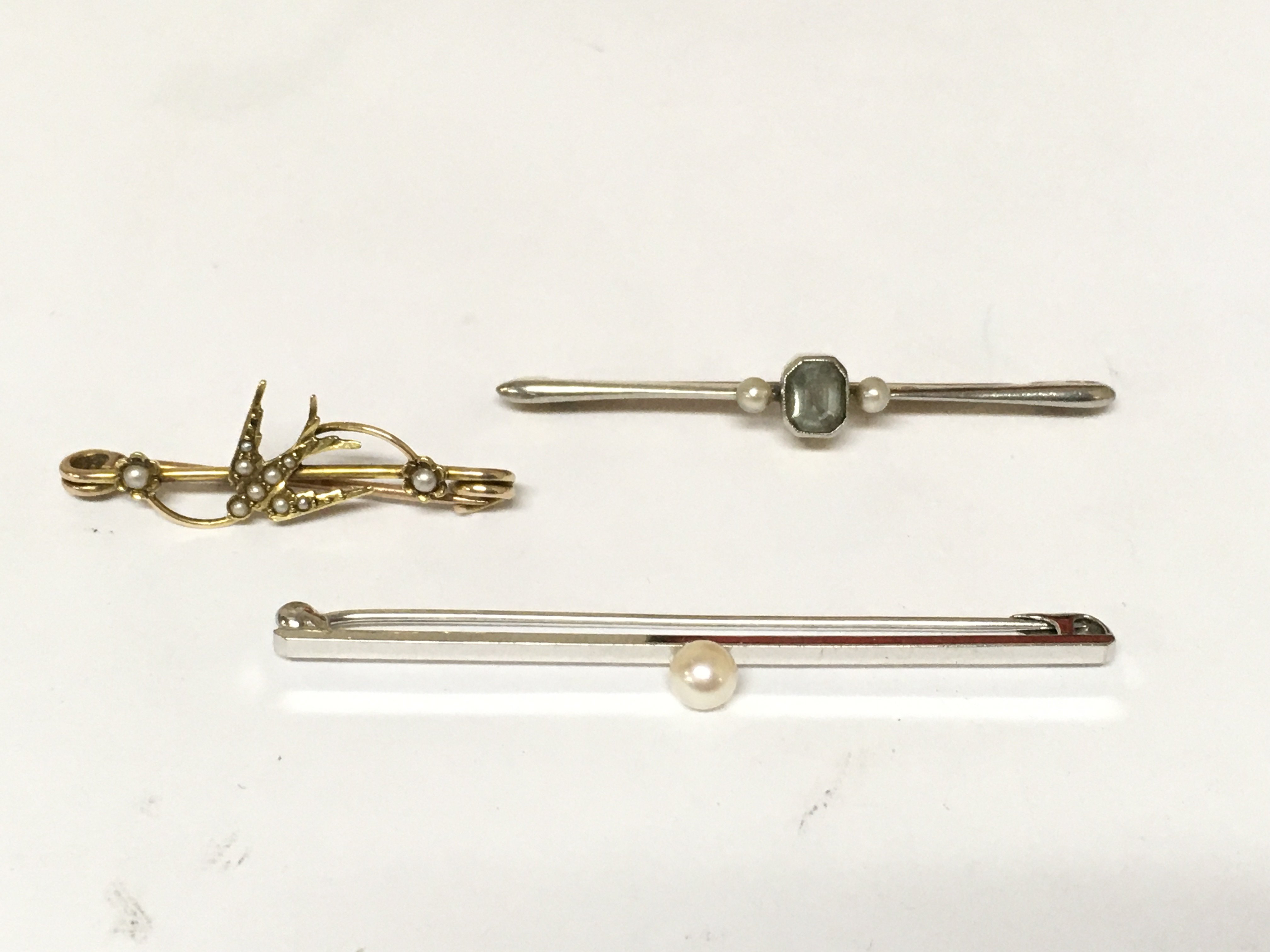 Three art deco style bar brooch&#2013266057۪s set with seed pearls.