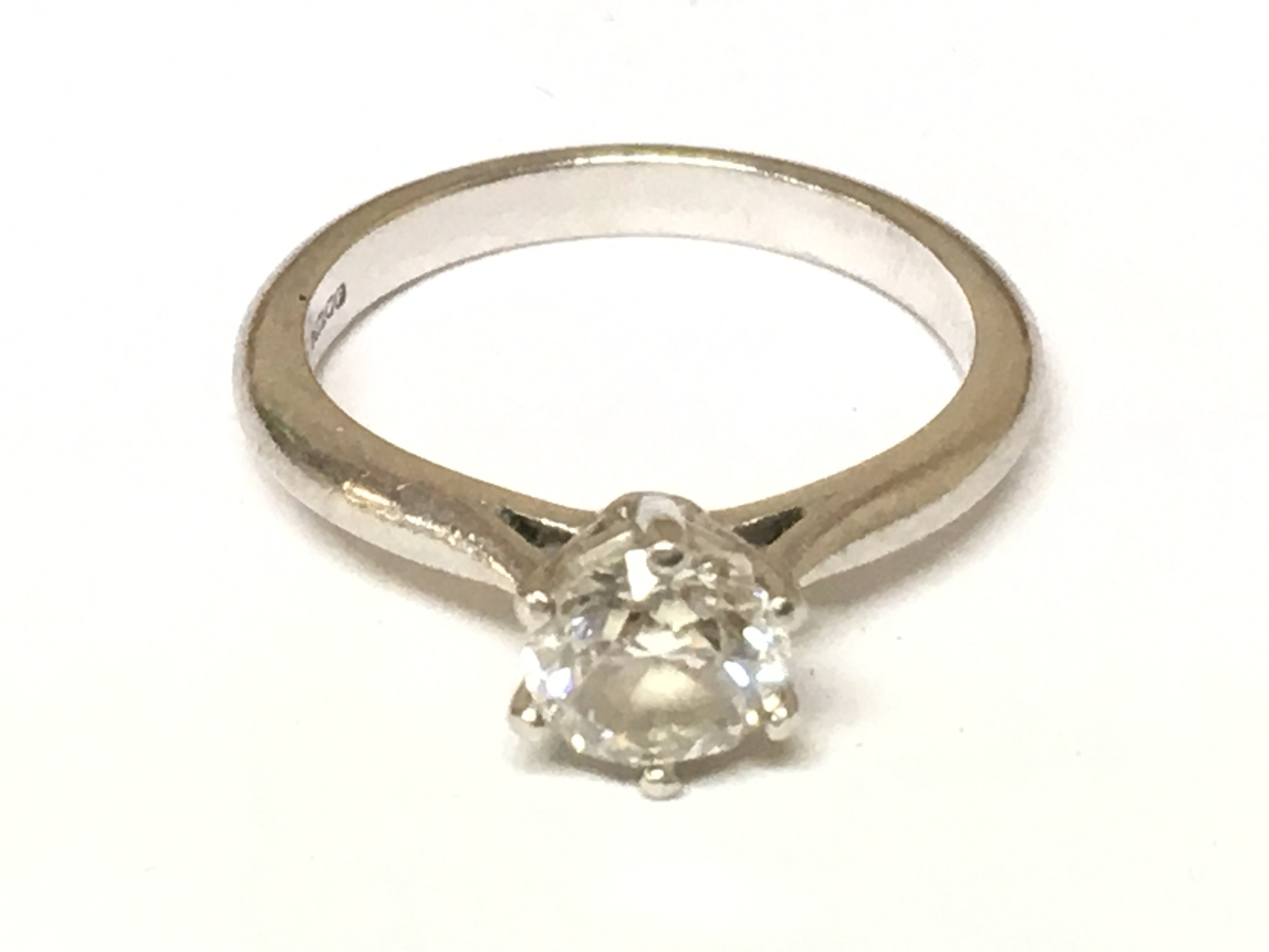 A platinum ring set with a 0.90ct diamond solitaire with GIA report. Size J and 4.54gPostage B