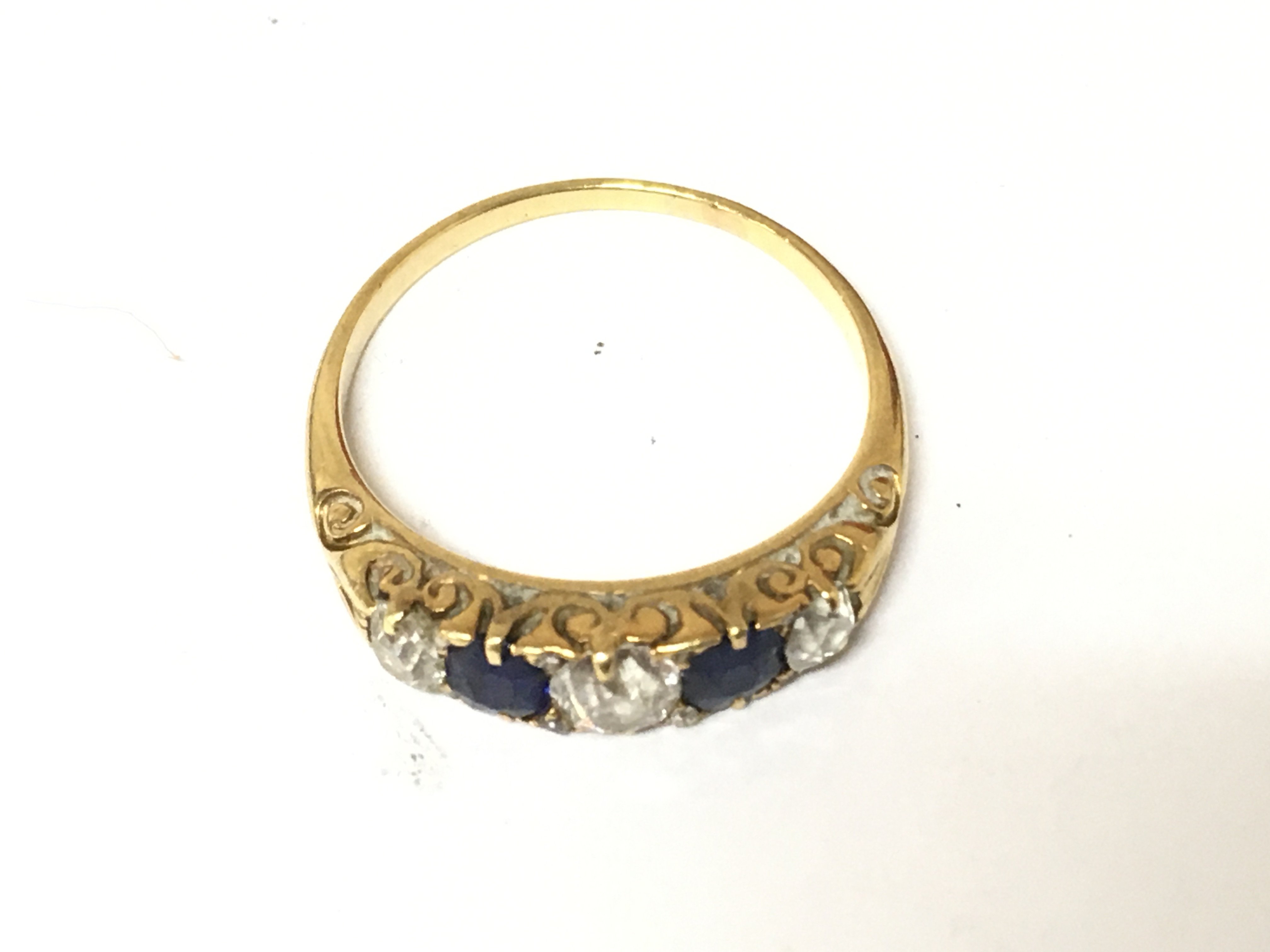 A yellow metal sapphire and diamond ring. Size R and 3.35g