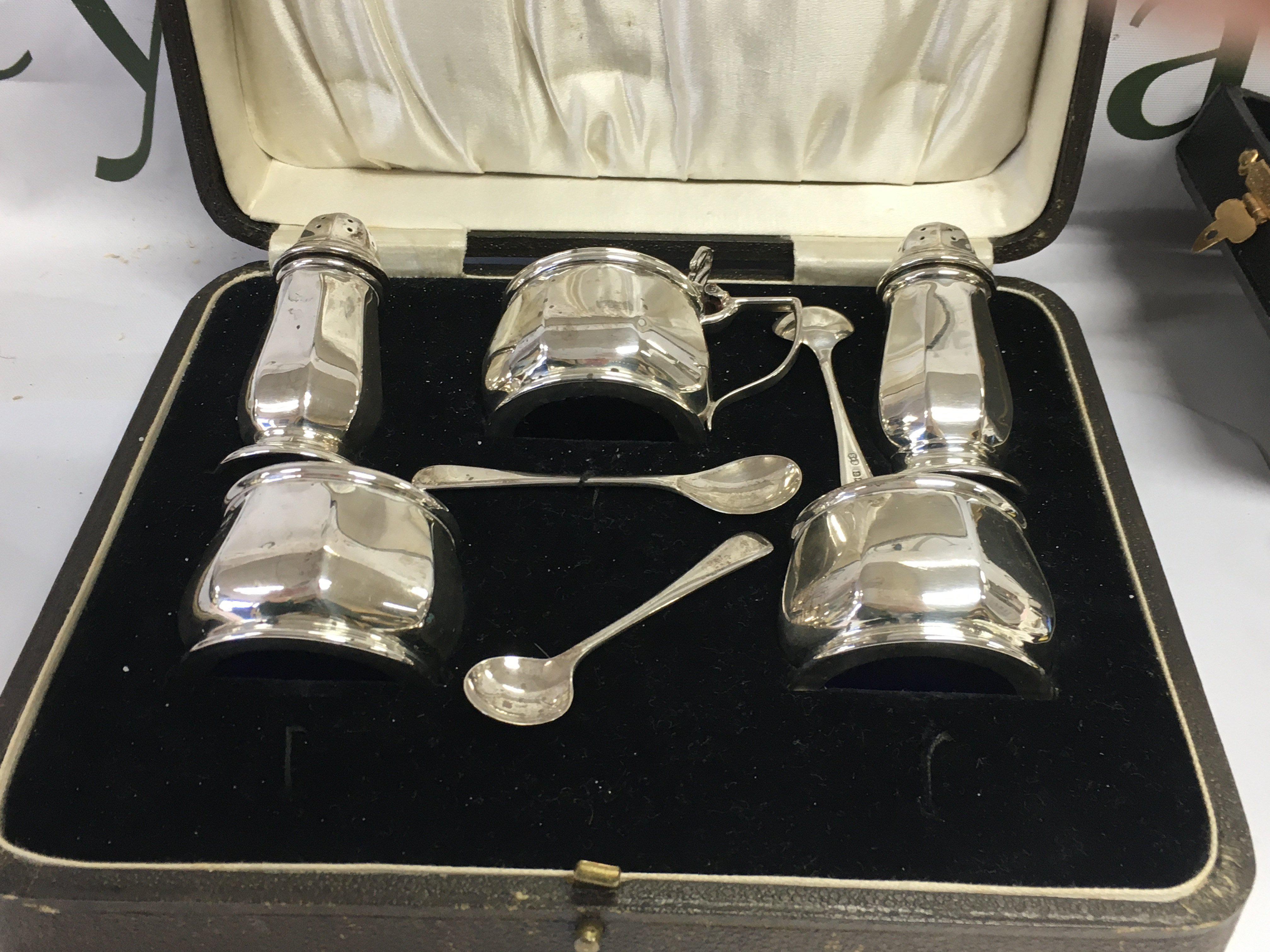 A five piece silver cruet set in original case .