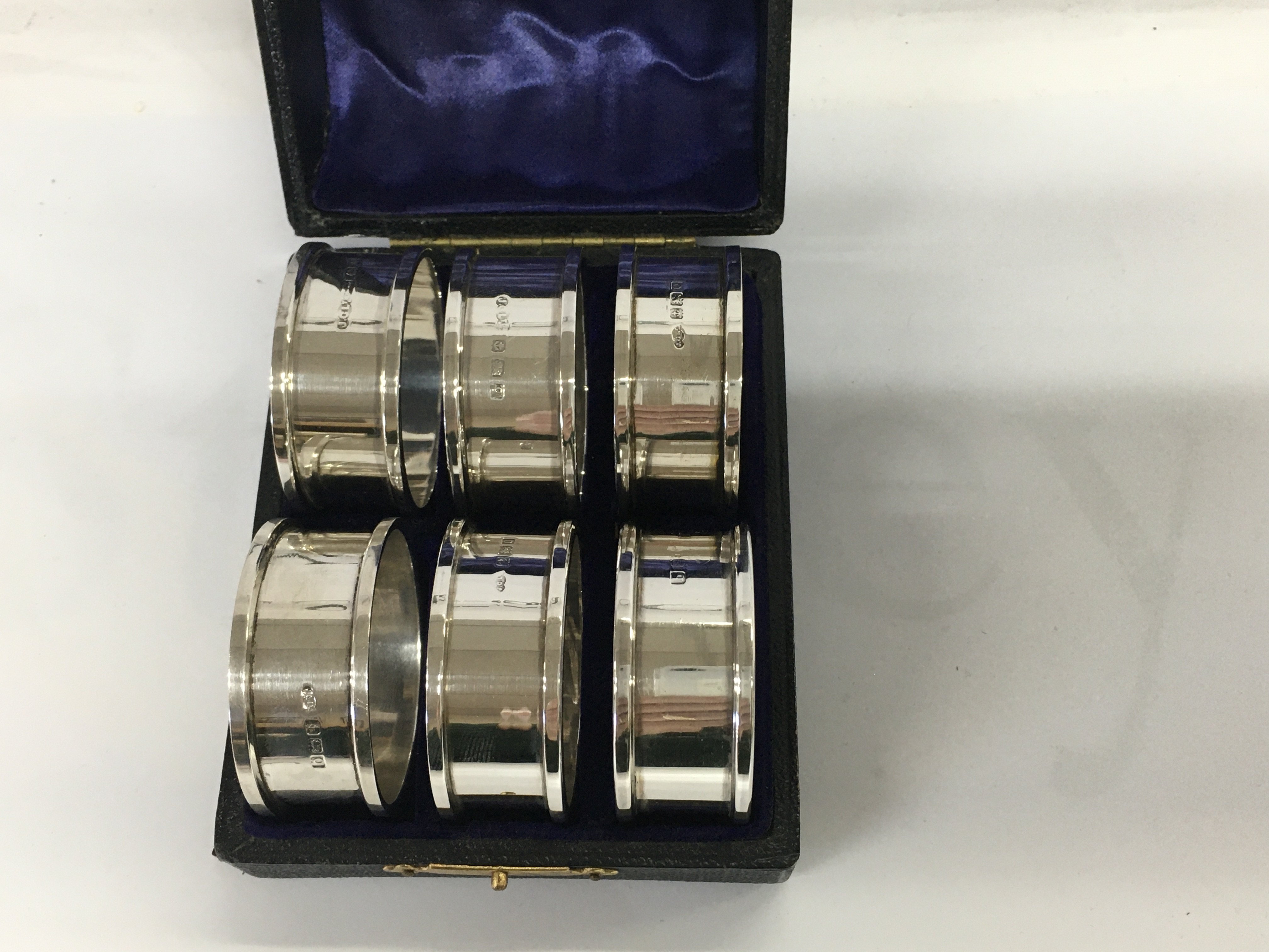 A cast set of six silver napkin rings 48 grams,