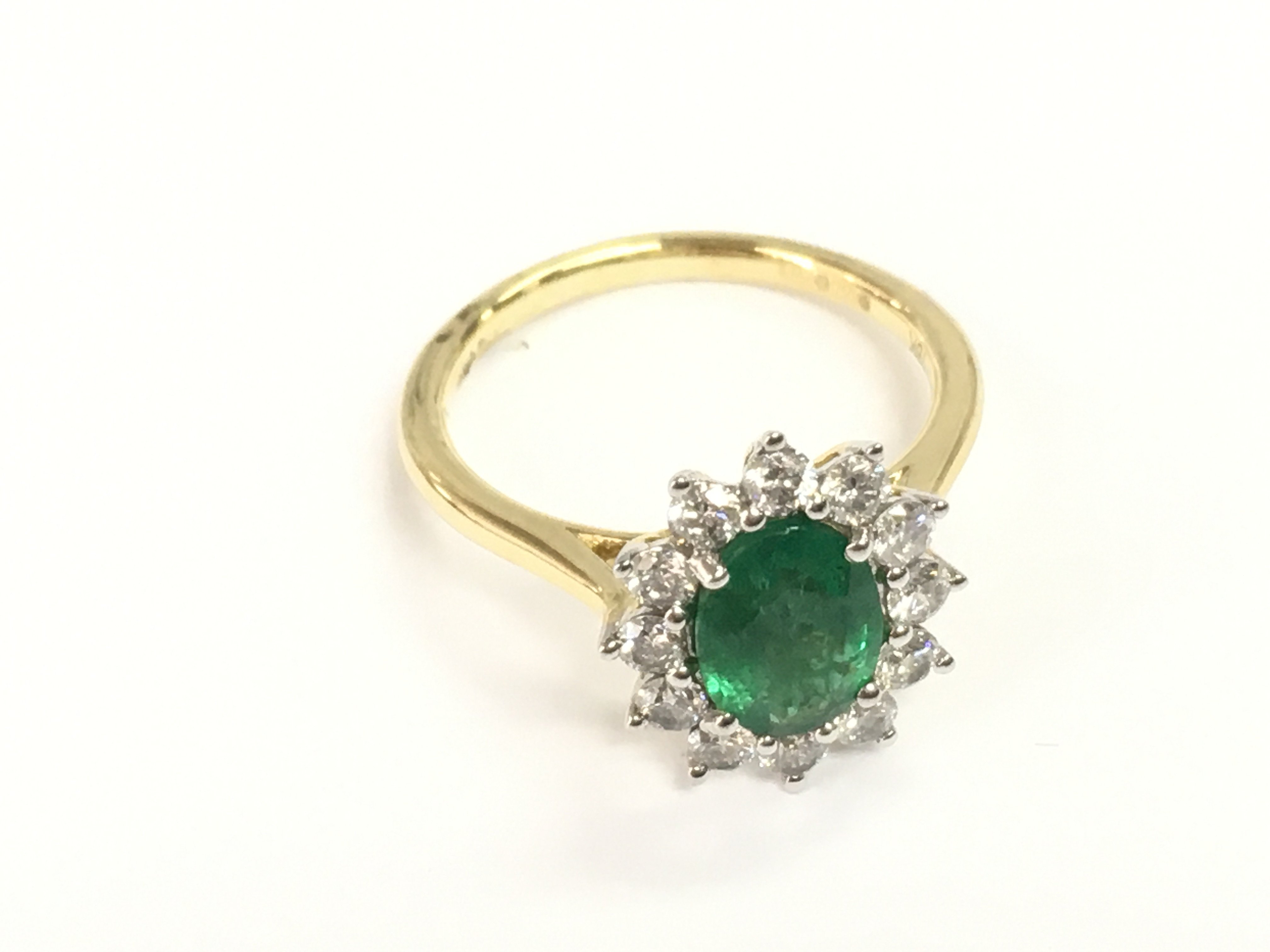 18ct white and yellow gold oval emerald no diamond cluster ring. Emerald 1.16ct and 0.60ct diamonds. Size M 1/2