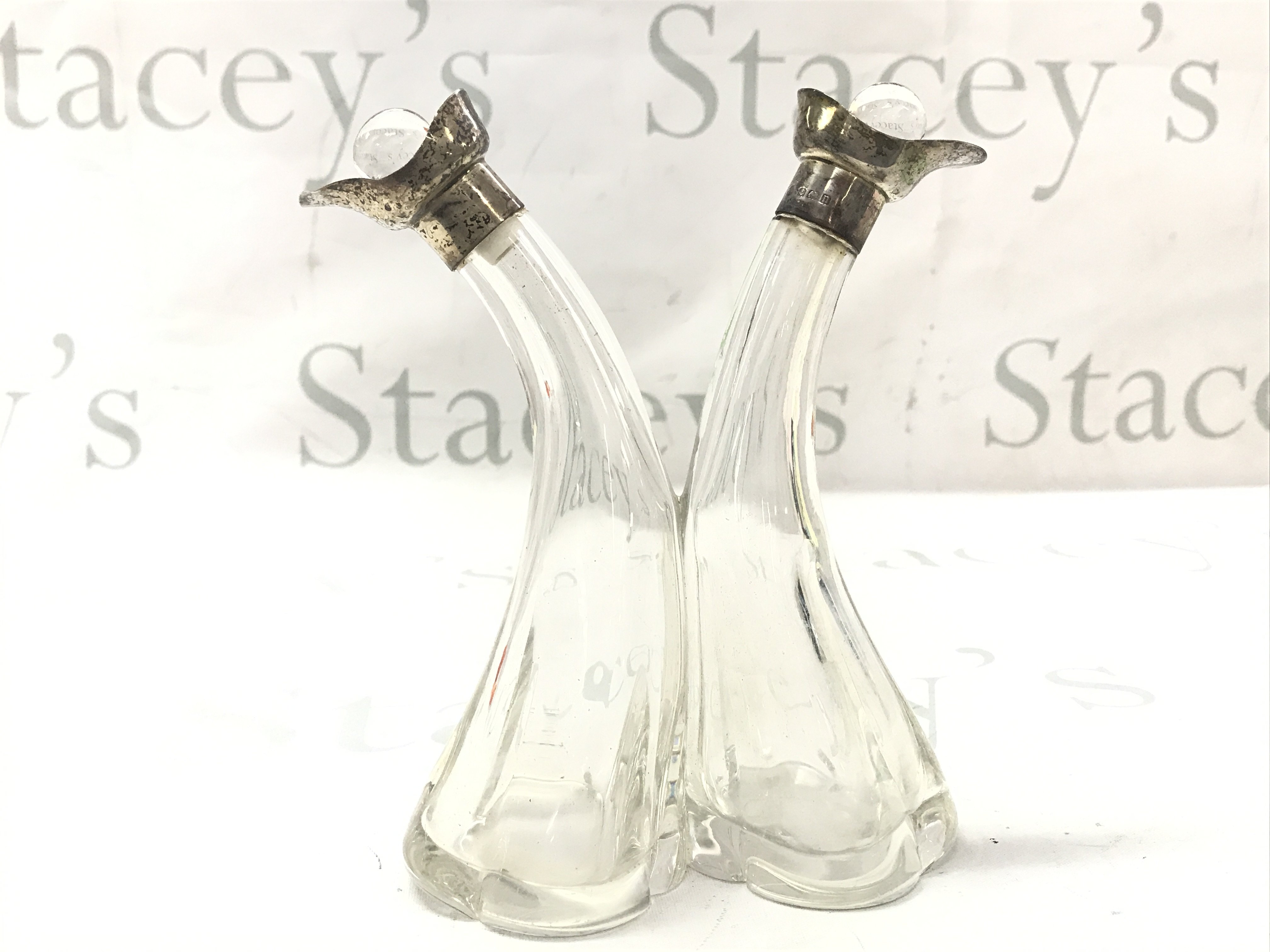 A Oil And Vinegar glass and silver hallmarked cruet , marked Birmingham 1912.17cm tall. This lot cannot be posted