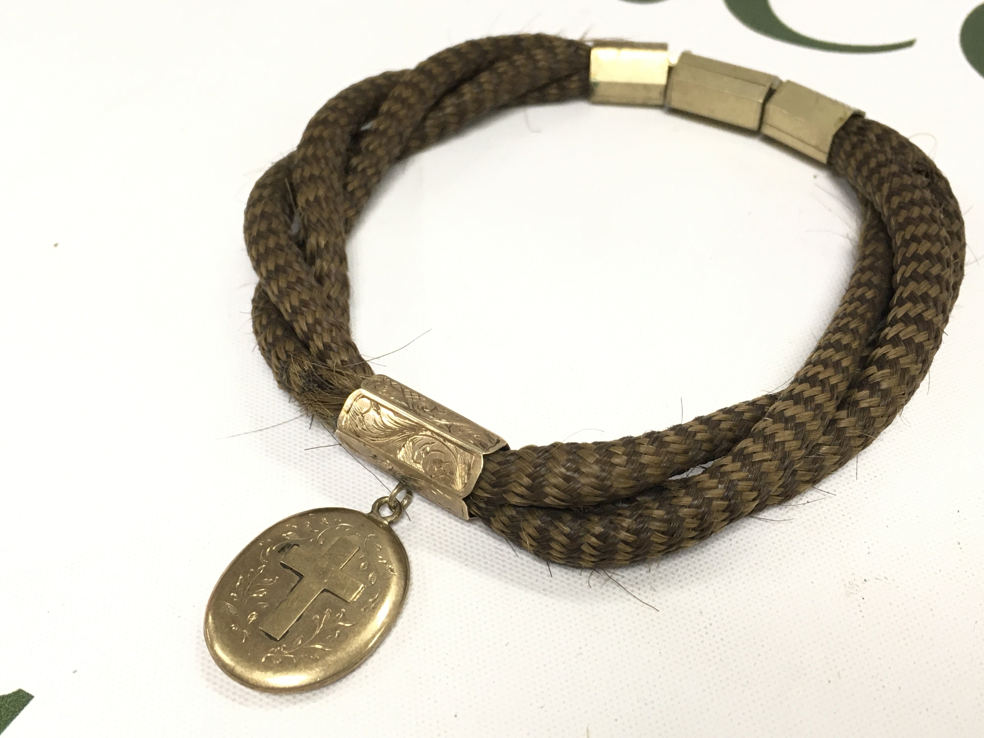 A Victorian hair bracelet with gold plated mounts