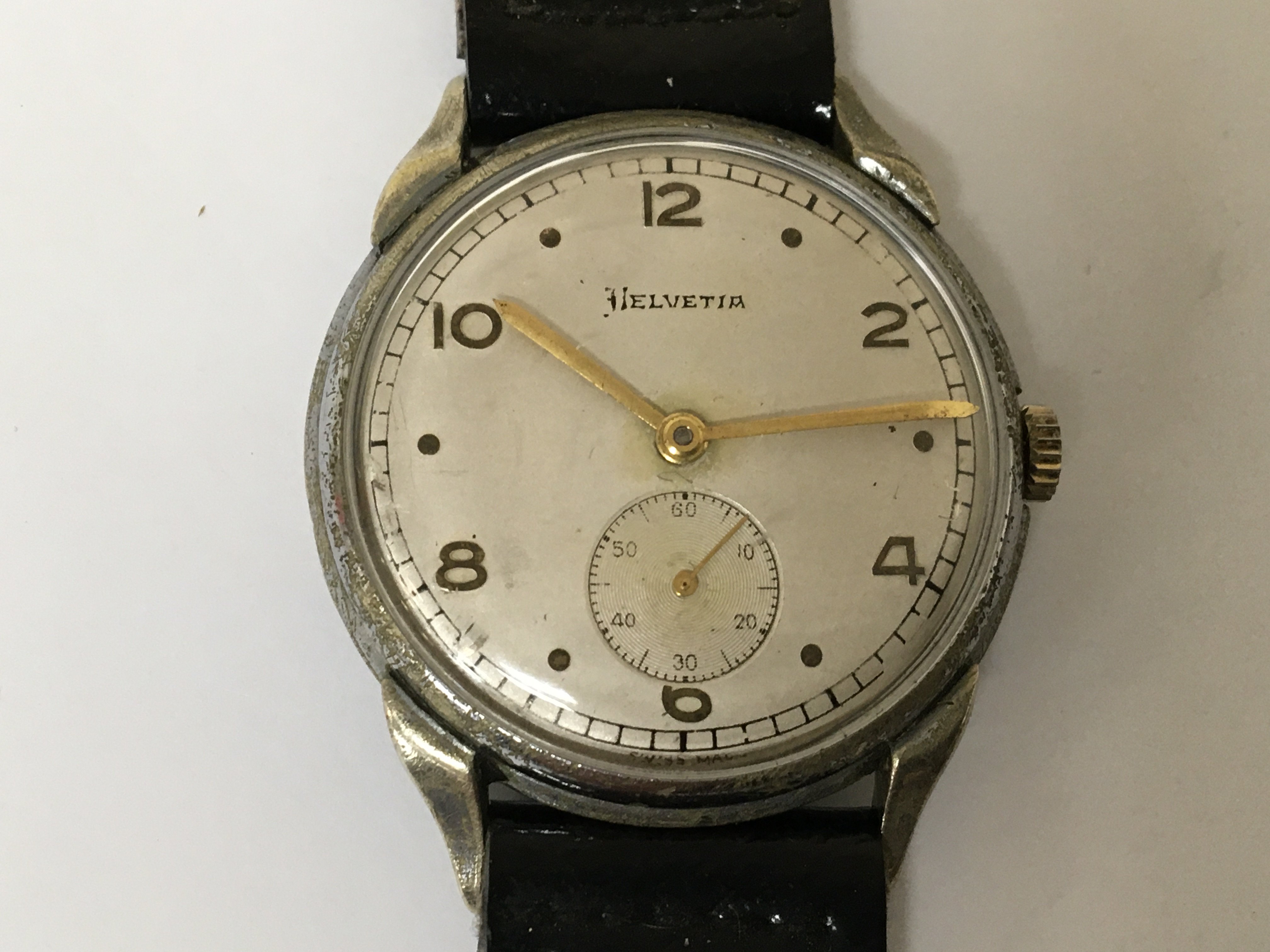 A German Third Reich Military watch maker Helvetia the dial with dot and even number markers second subsidiary dial the case with serial number D40216H watch seen working.