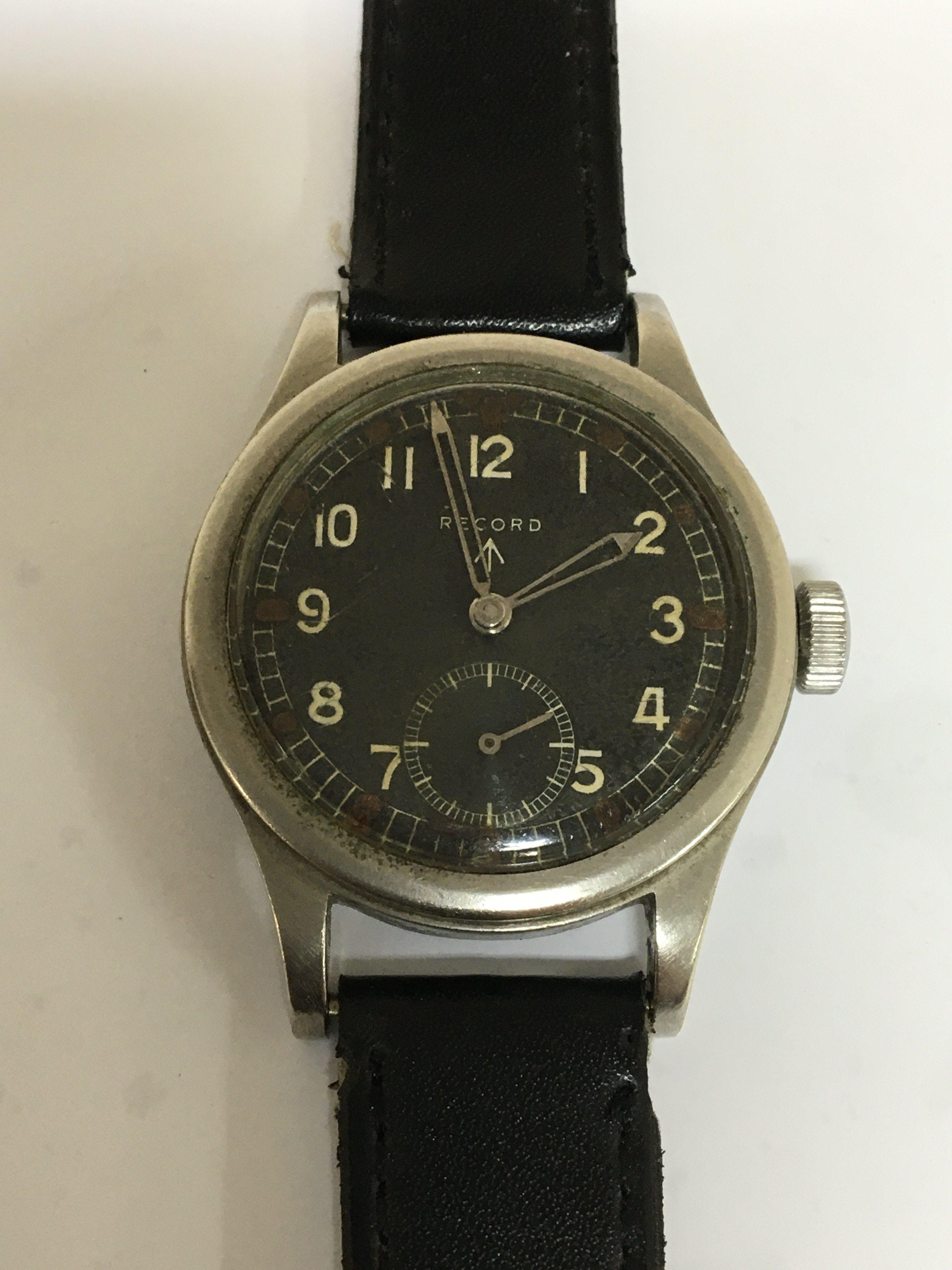 A Good Example of II world war British Military issue watch known as The Dirty Dozen maker Record the black dial with illuminated batons military symbol and second subsidiary dial seen working. The reverse with model and serial numbers L33265 551112.