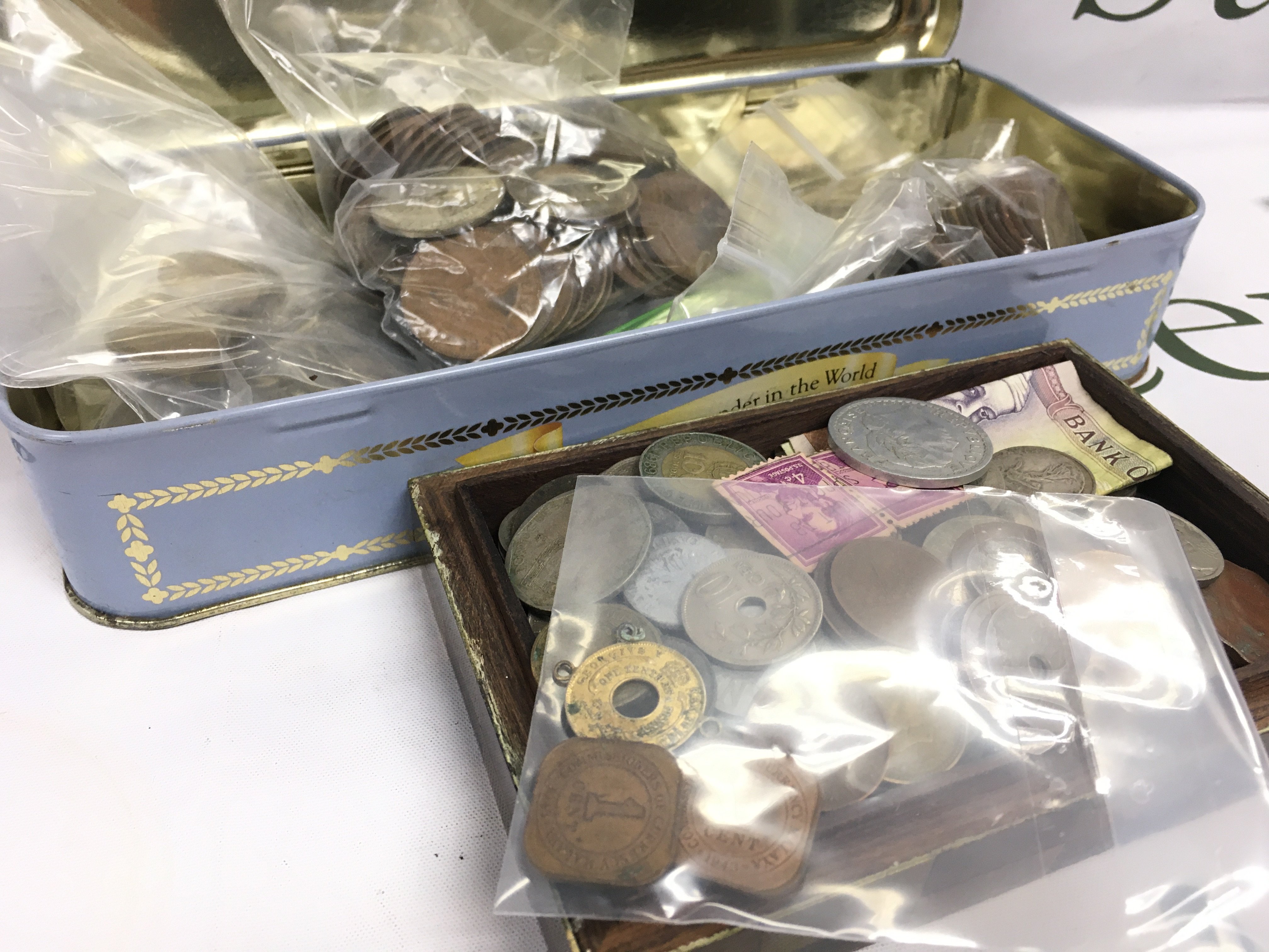 A tin and box of World coins . Postage catB