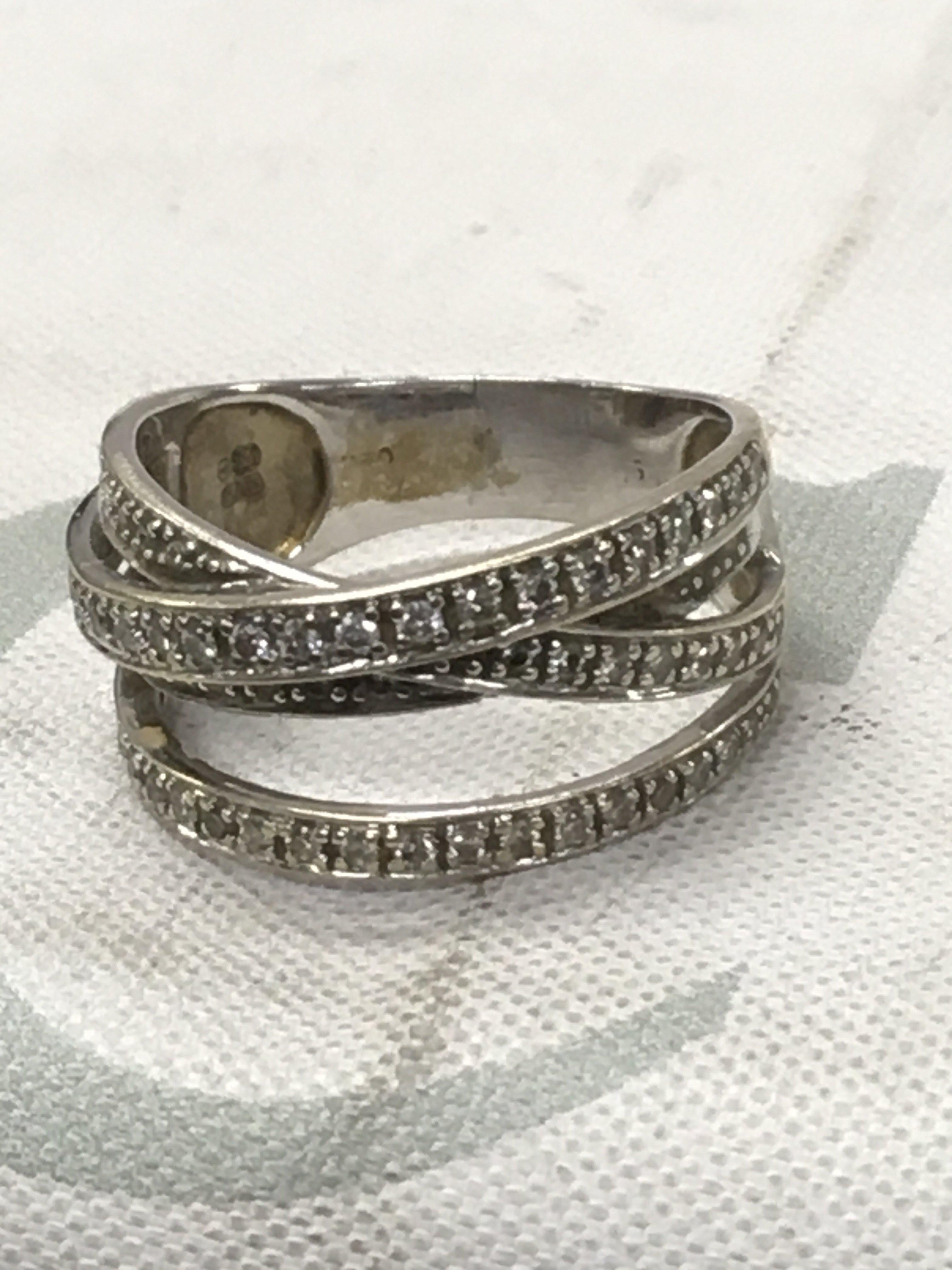 A 18 ct gold diamond cross over ring 5.5 grams size M .