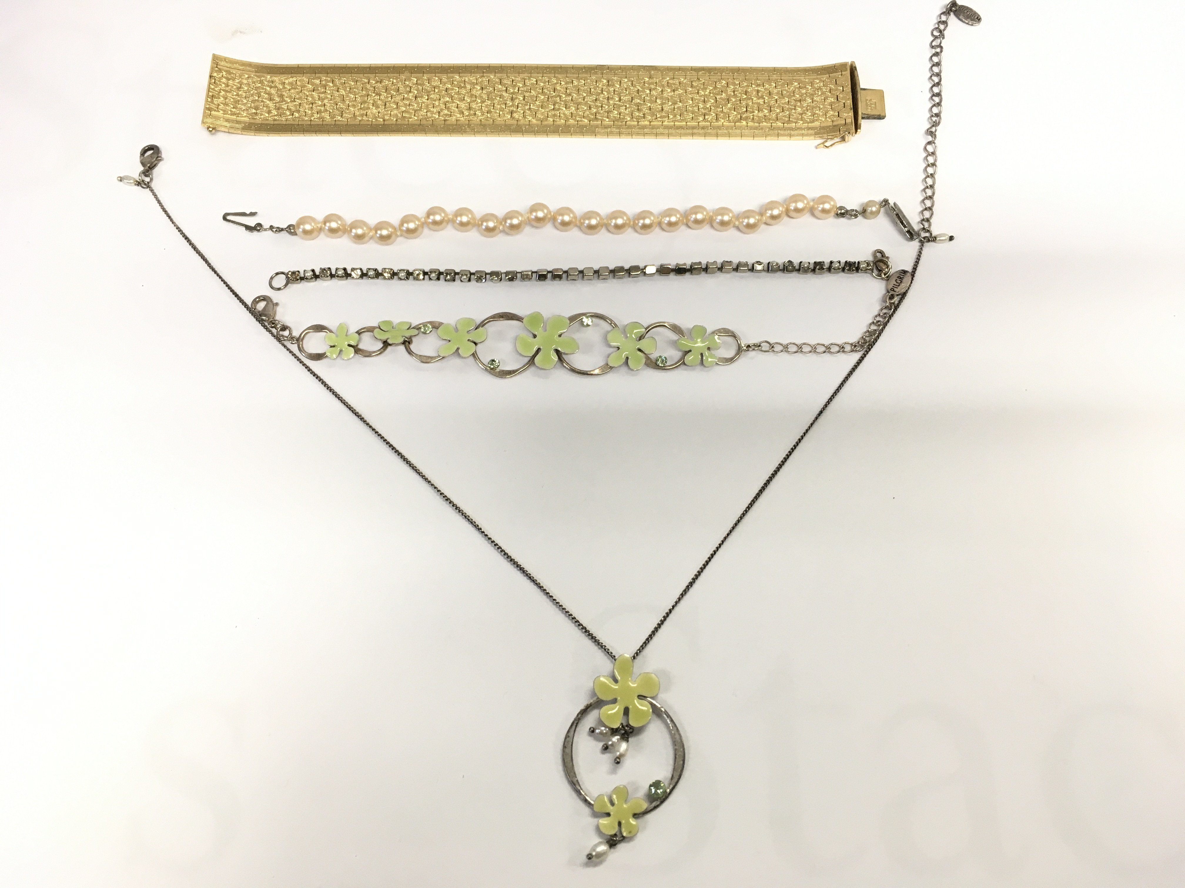 Four bracelets and a floral design necklace. Postage B