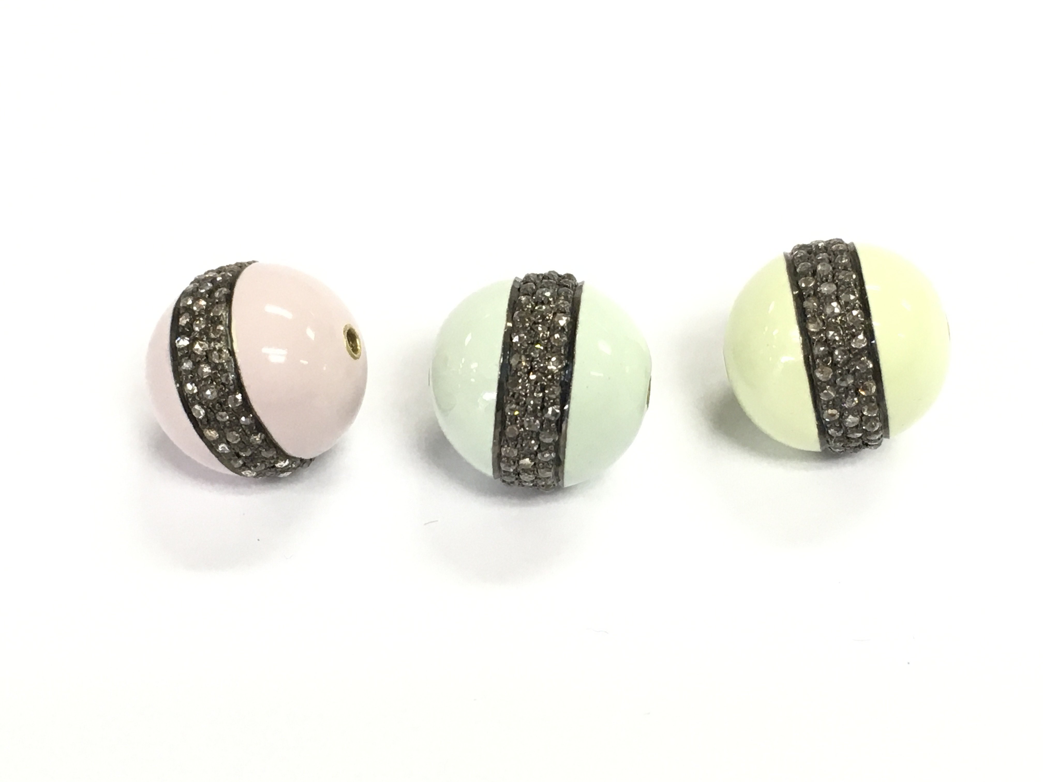 Three silver beads coated in enamel pastel colours of blue green and pink. Each set with three rows of diamonds totalling 1.35ct so 0.45ct per bead.