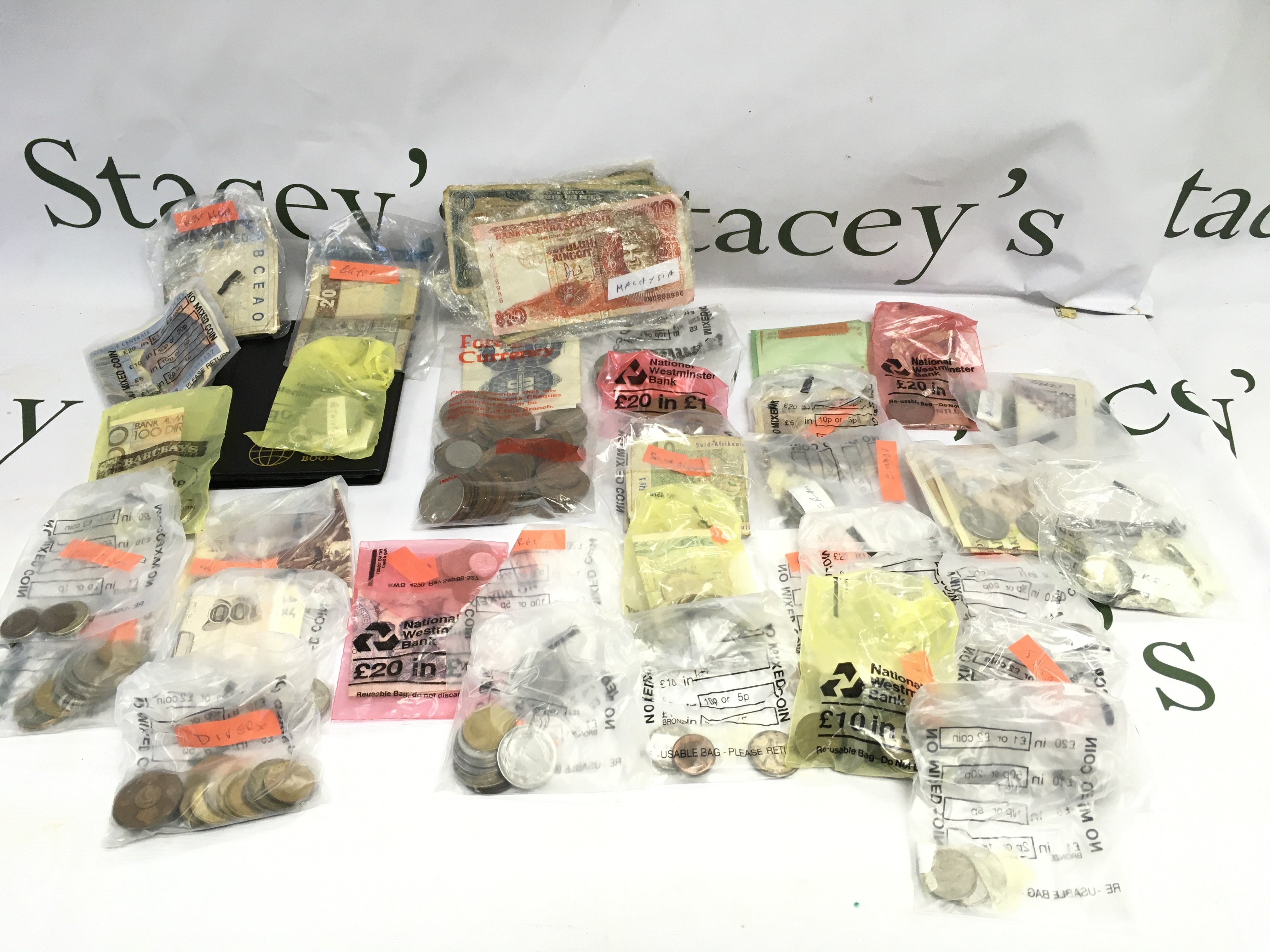 A collection of various world coin and bank notes including USA Malaysia Egypt etc.