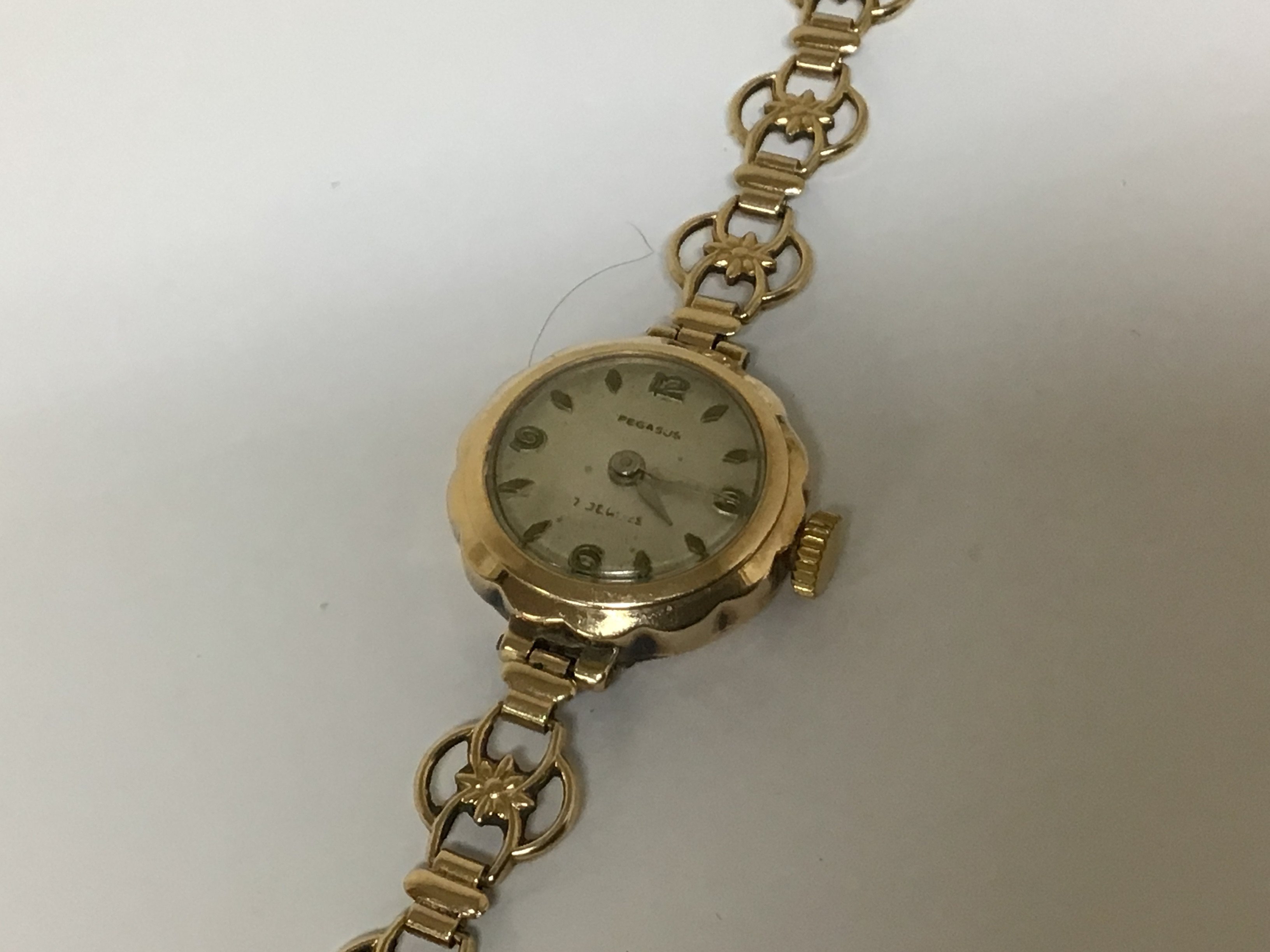 A Vintage 9carat gold ladies watch maker Pegasus with an attached 9carat gold open link bracelet. Weight 12g