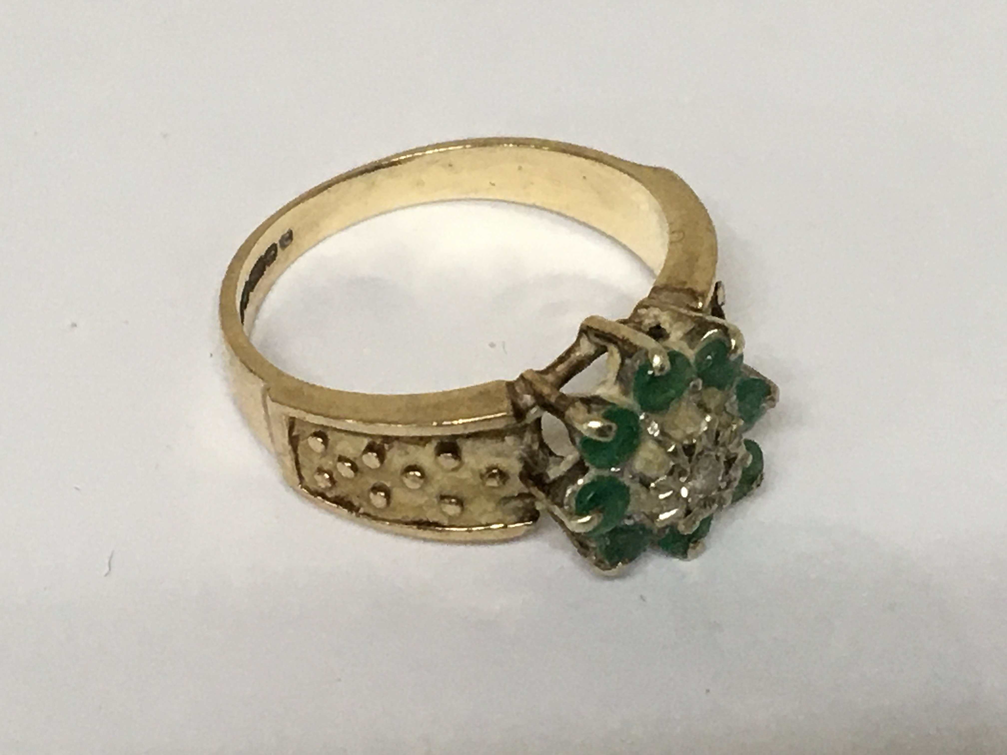 A9carat gold ring set with a pattern of emerald and small diamonds. Weight 4g
