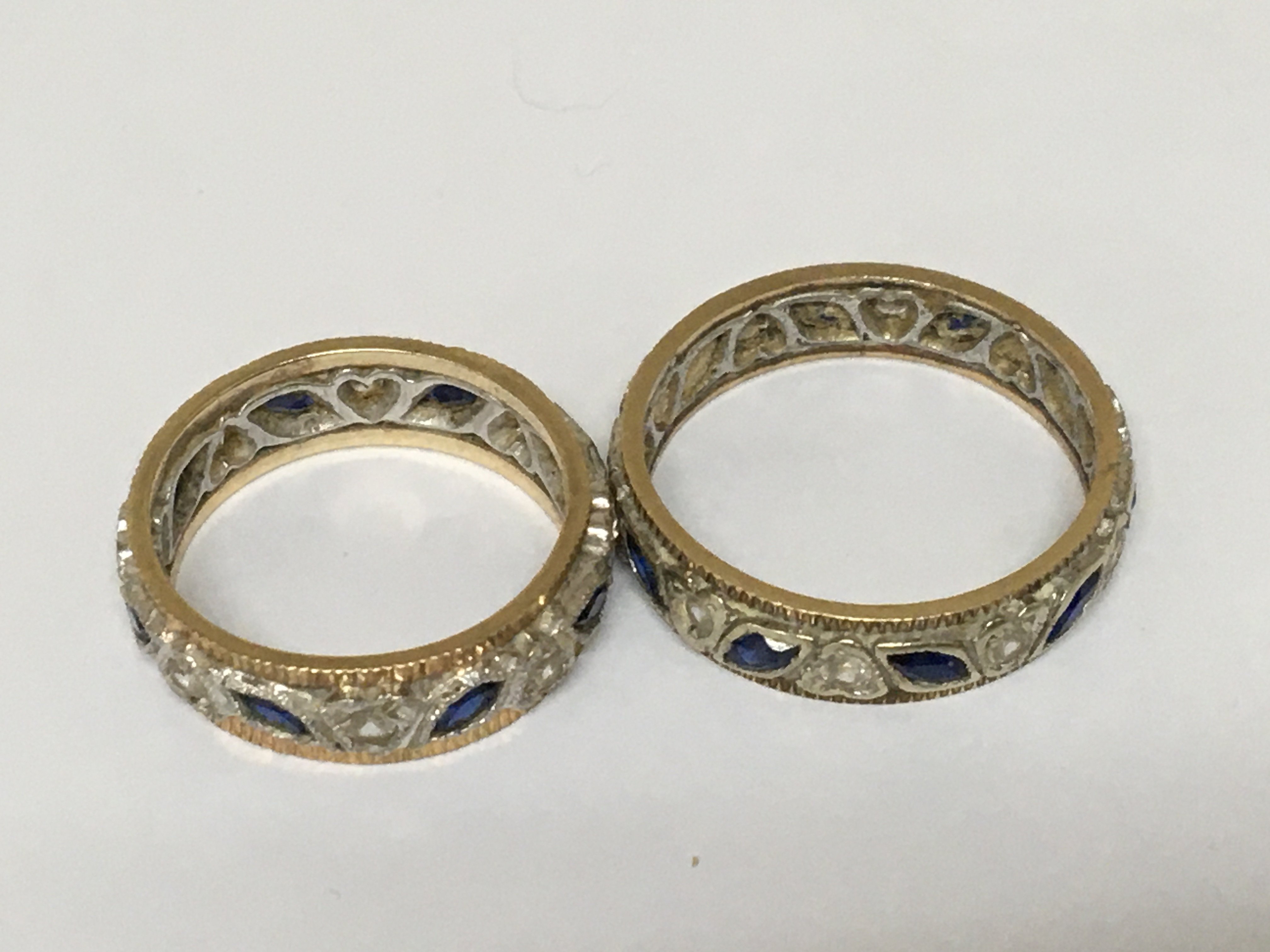 Two unmarked gold and white metal eternity rings set with sapphire and chip diamond. (2) weight 7g.