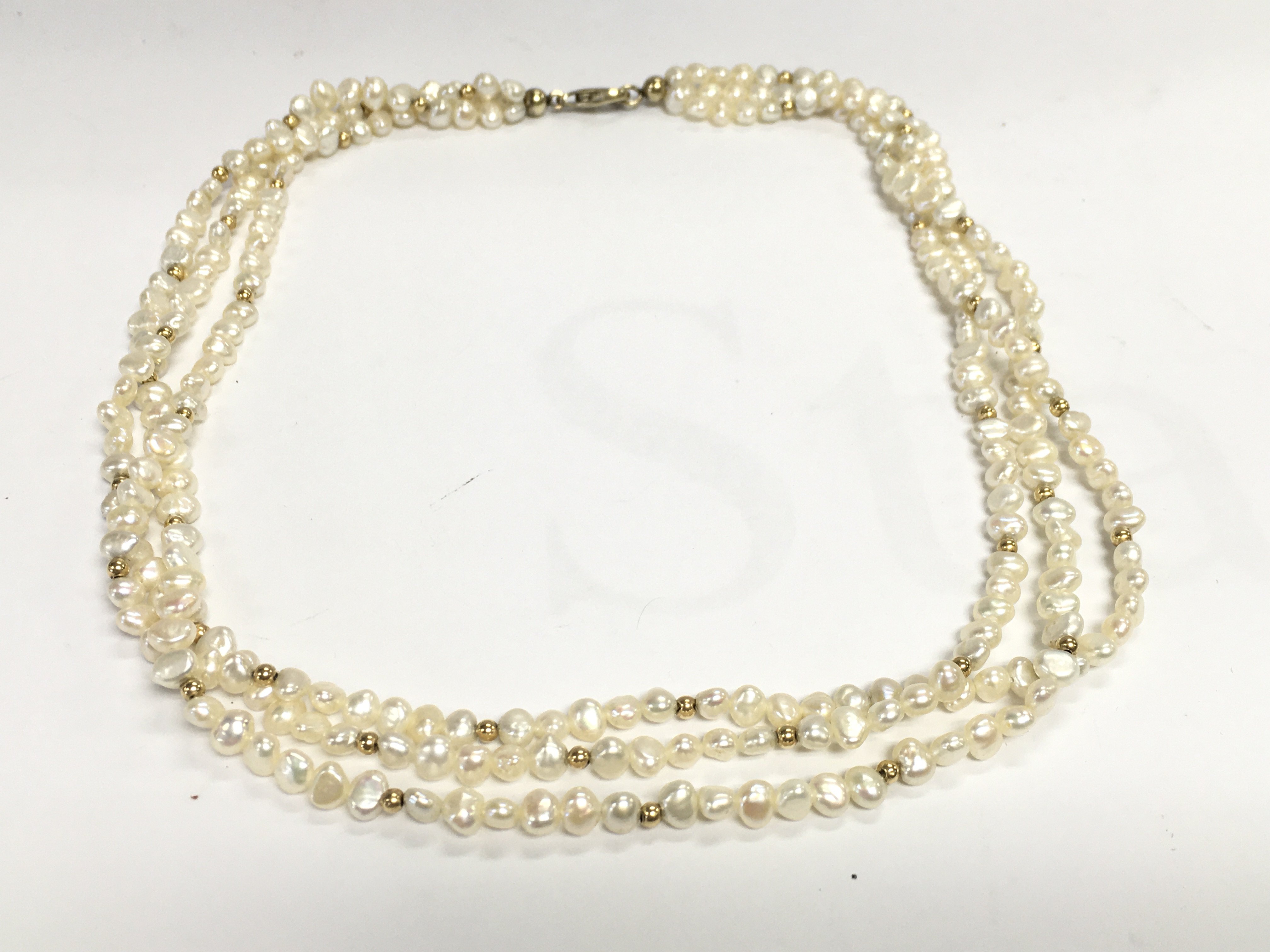 A three string pearl necklace. Approximately 47cm length. Postage A