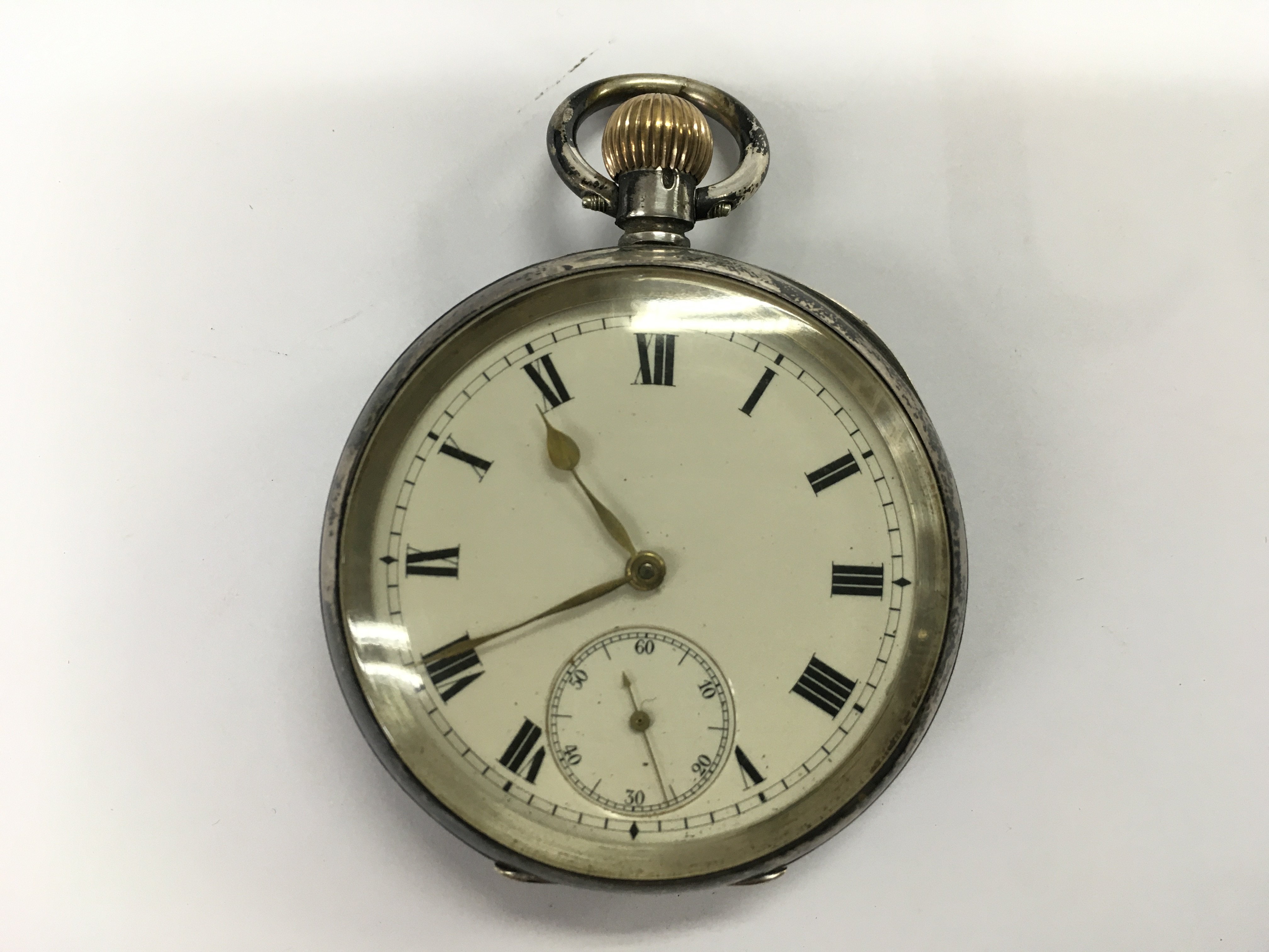 A silver cased button wind pocket watch. Winds and runs. Approximately 50mm case and 105g