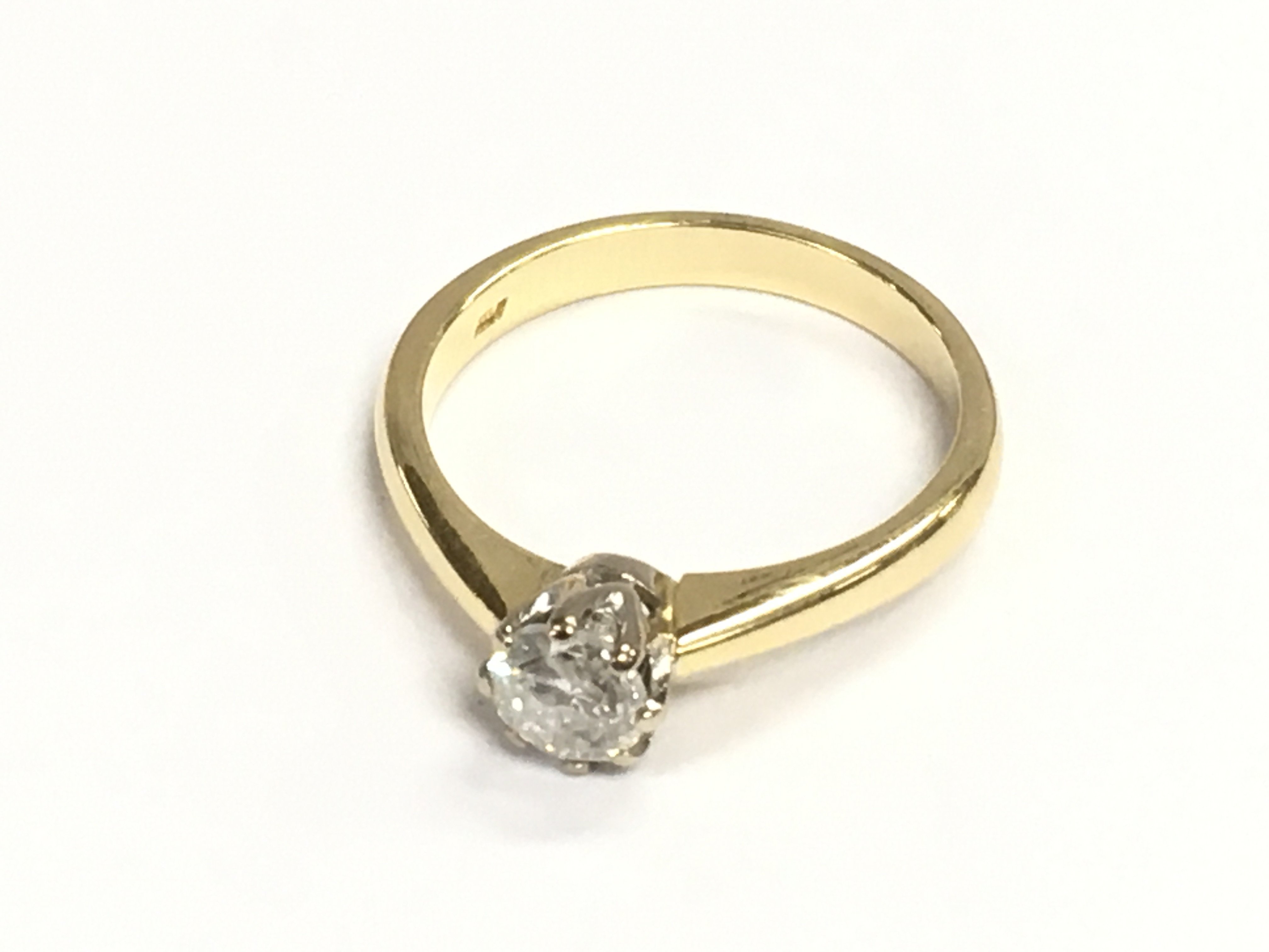 An 18ct gold diamond solitaire ring. Diamond 0.65ct approximately. Size Q 1/2