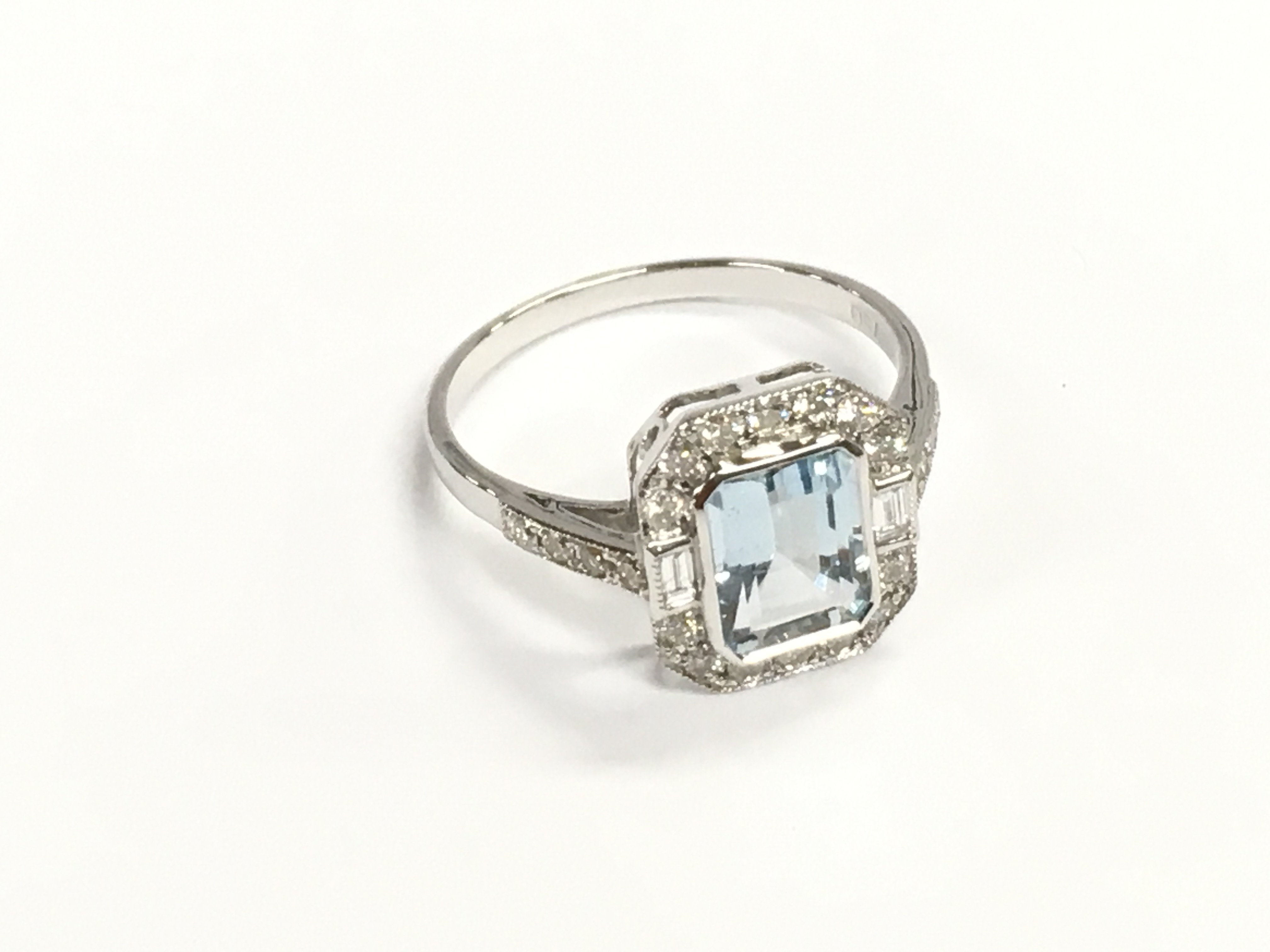 18ct white gold art deco style aquamarine ring with round and baguette cut diamonds. Aquamarine 1.42ct and diamonds 0.50ct. Size O