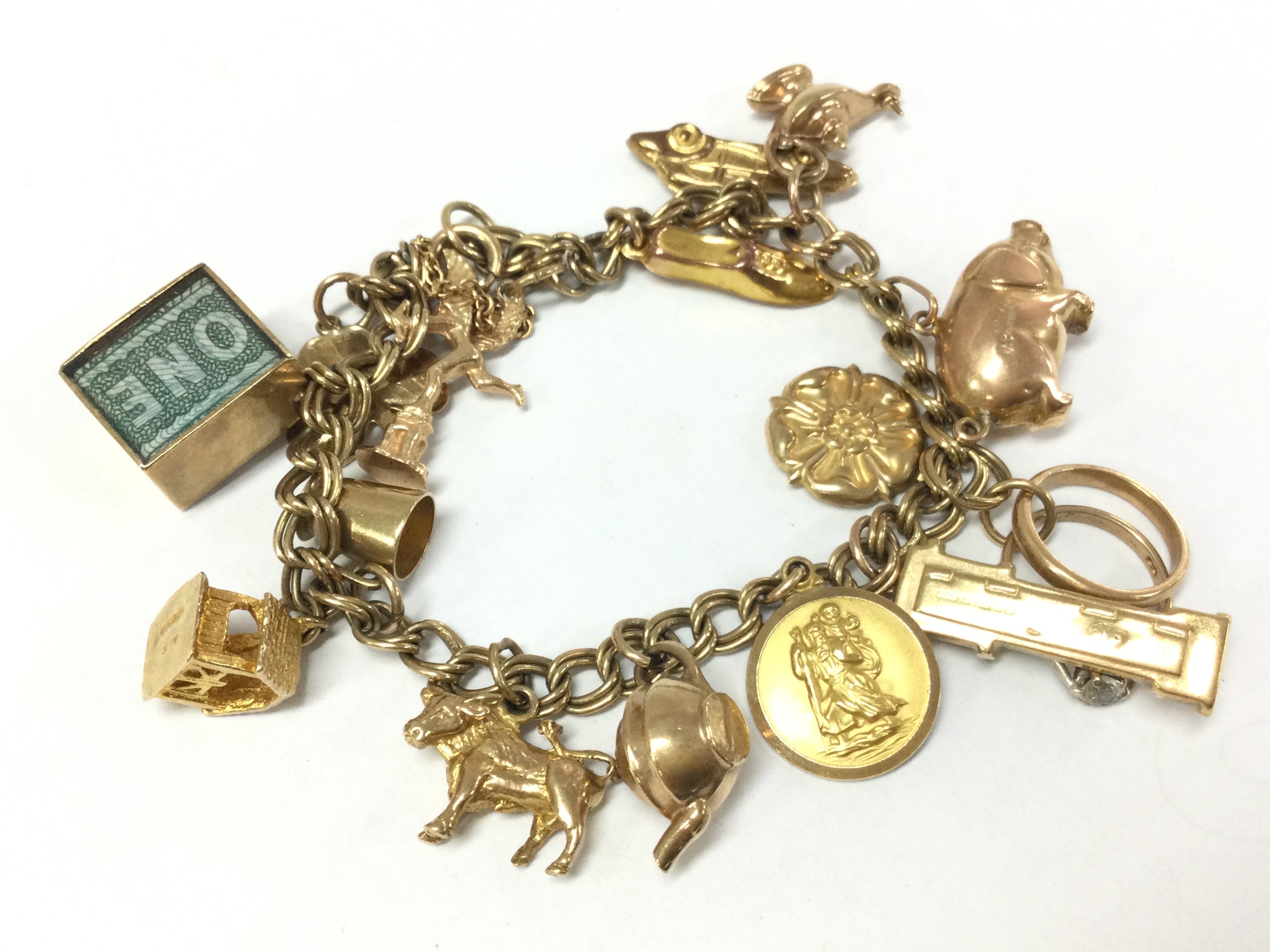 A 9ct gold charm bracelet , 26.1g total weight postage category A
