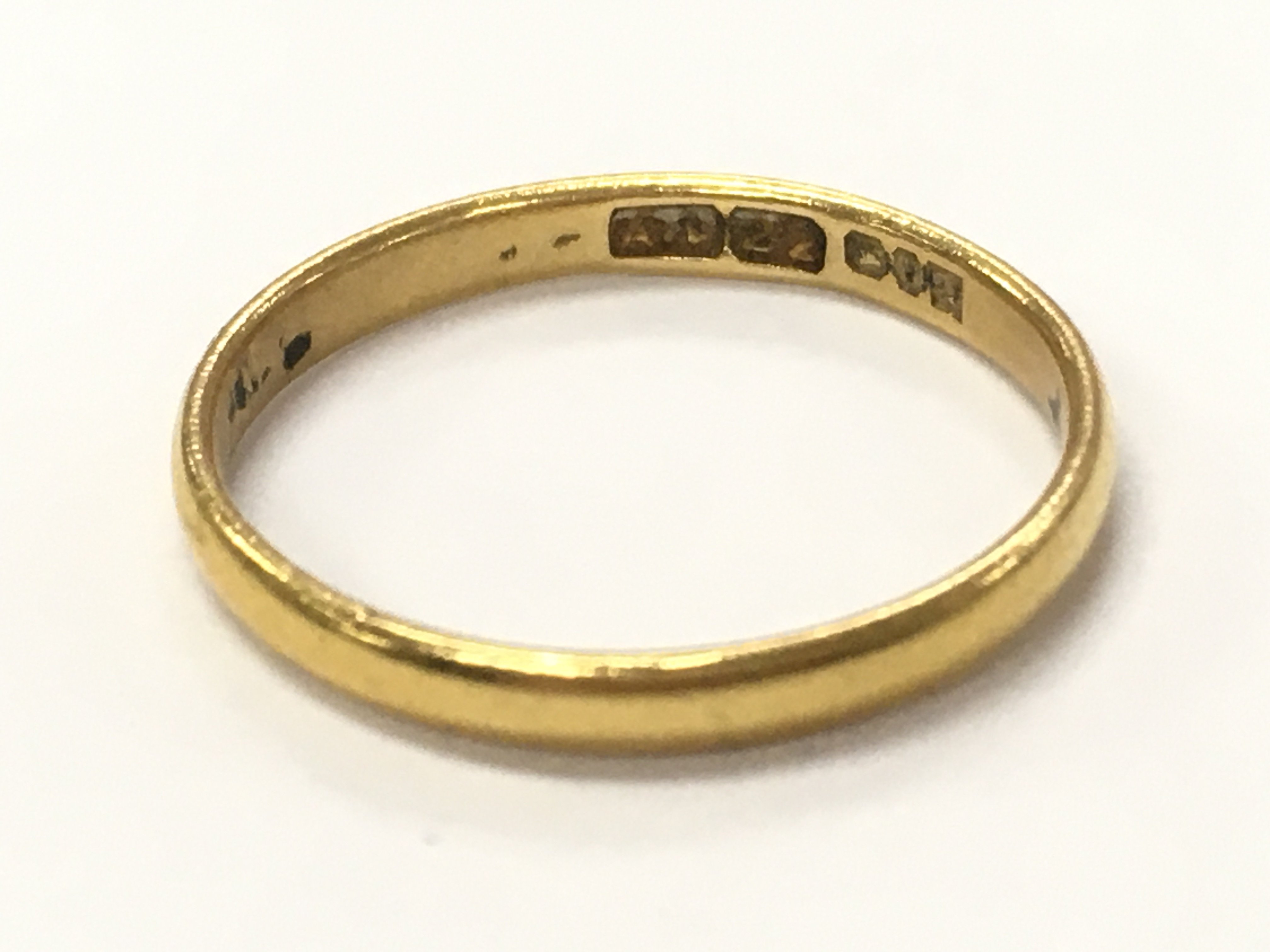 A 22ct wedding band , size M , 2.1g total weight. postage category A