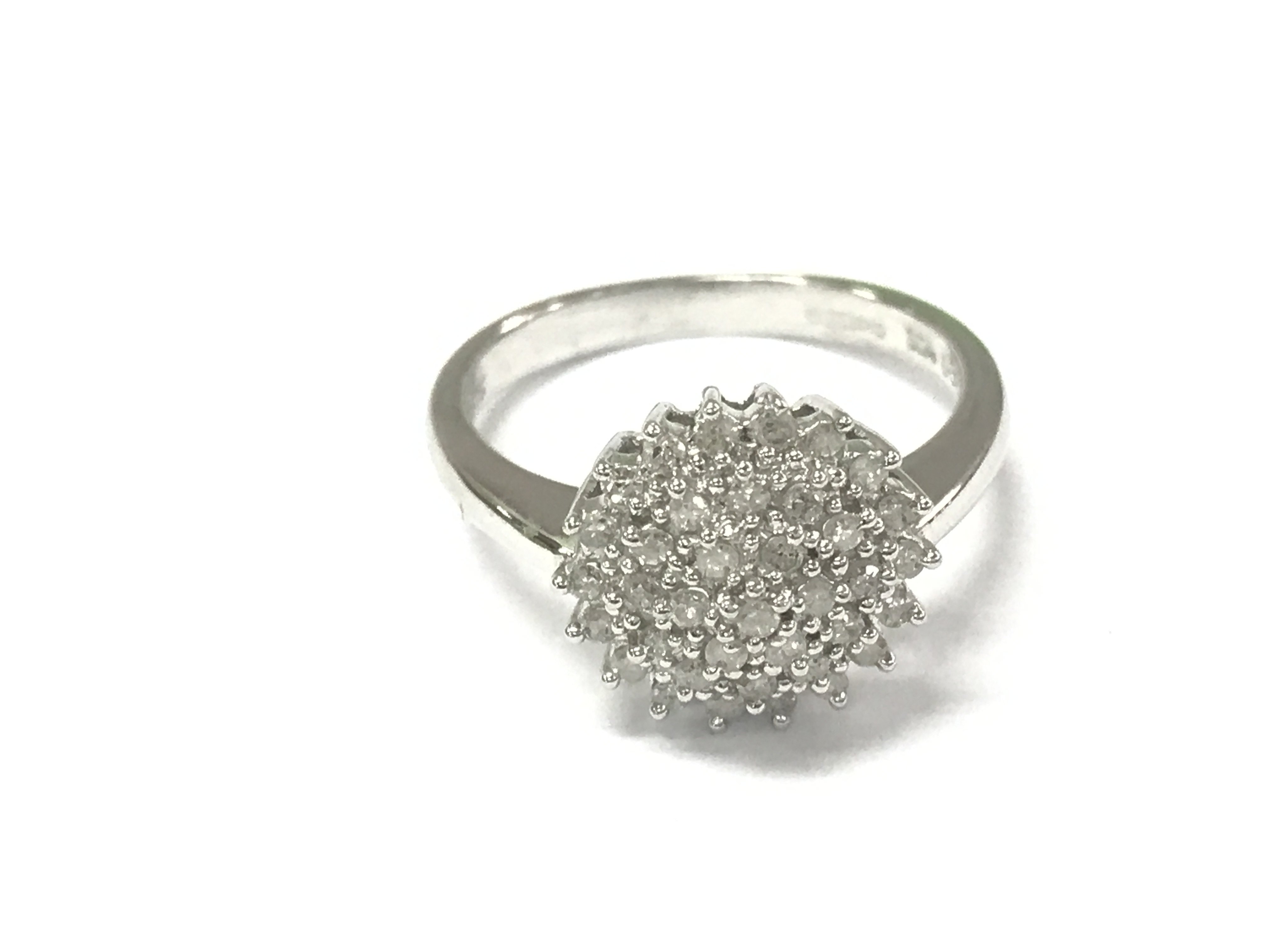 A 9ct white gold diamond cluster ring. Size M and 3.28g Postage A