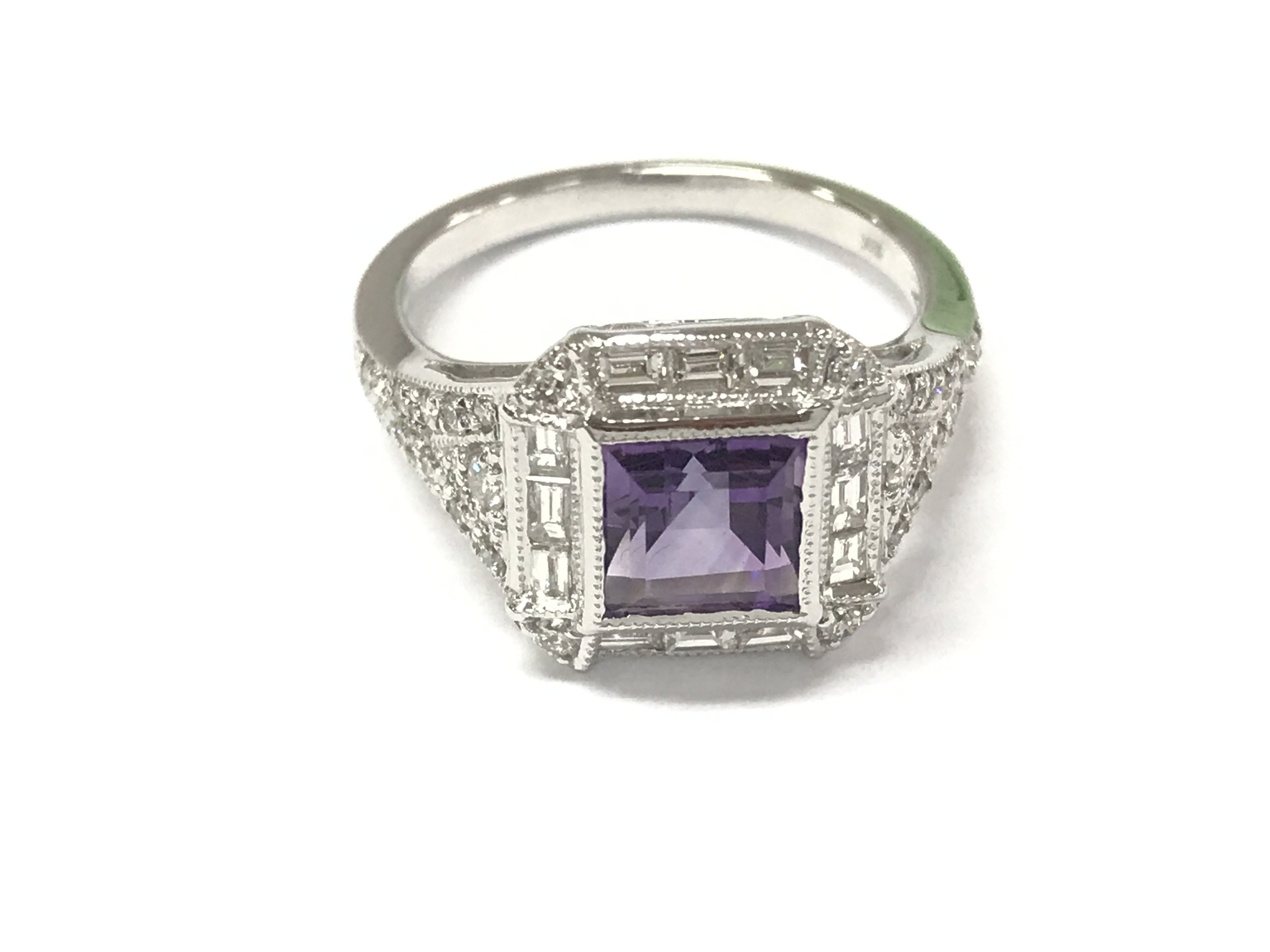 An 18ct white gold art deco style ring set with a square princess cut amethyst surrounded by baguette cut and round cut diamonds with diamond shoulders. Diamonds 0.61ct approximately. Size M 1/2. Postage A