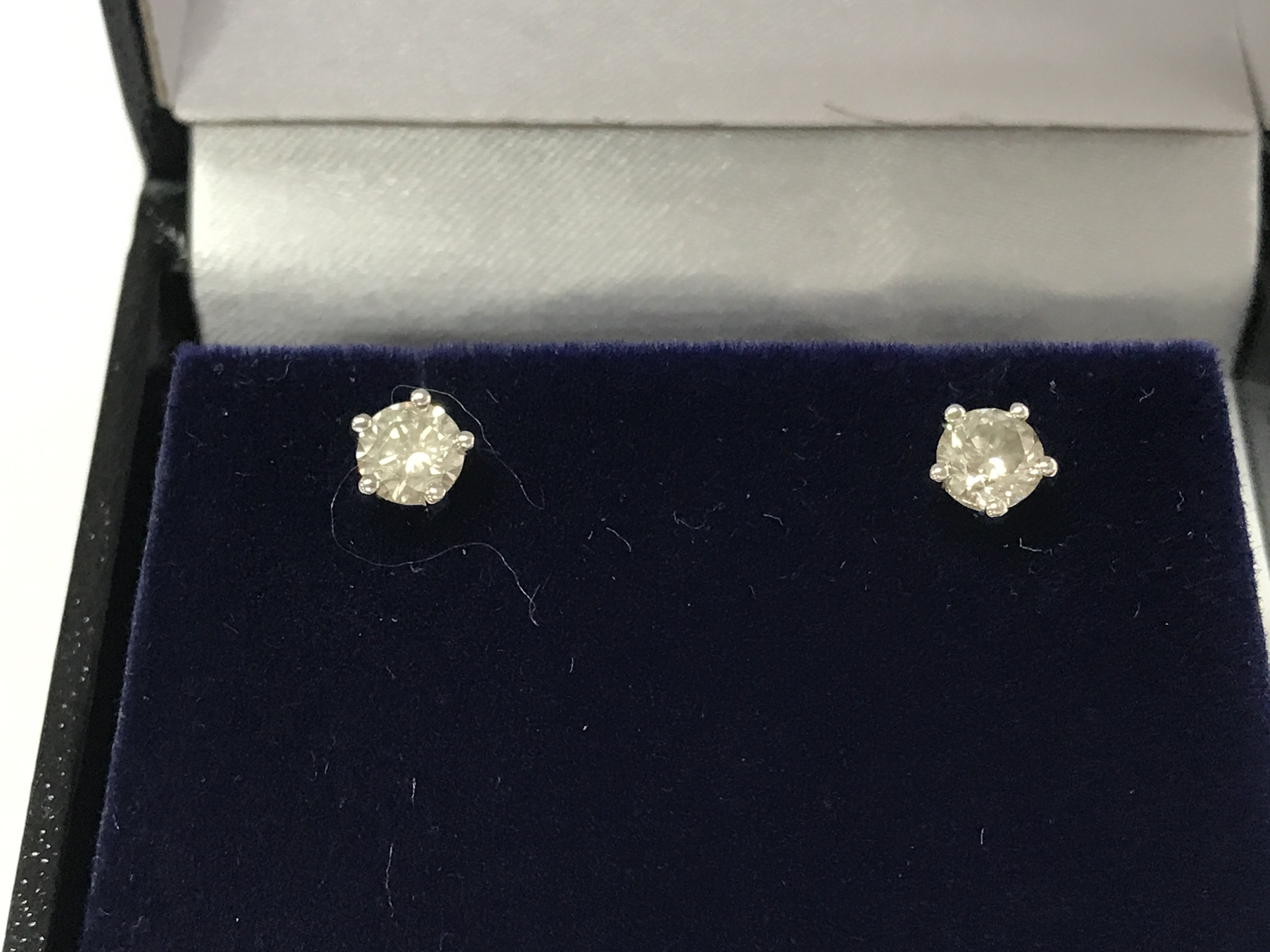 A pair of 18ct white gold 5 claw set diamond solitaire studs. Comes with gemological report. Postage B