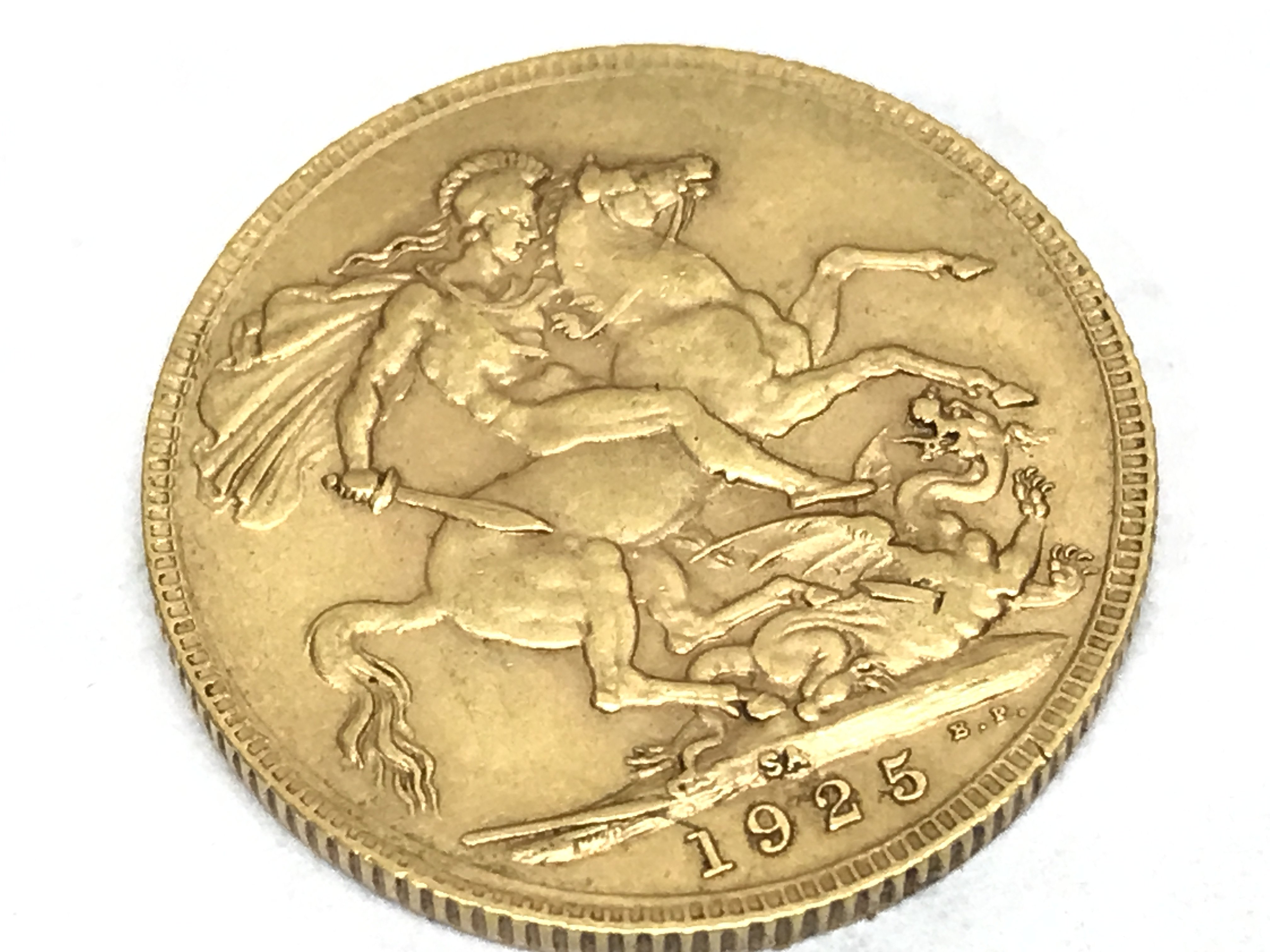 A 1925 gold full sovereign with South Africa mark. Postage category A