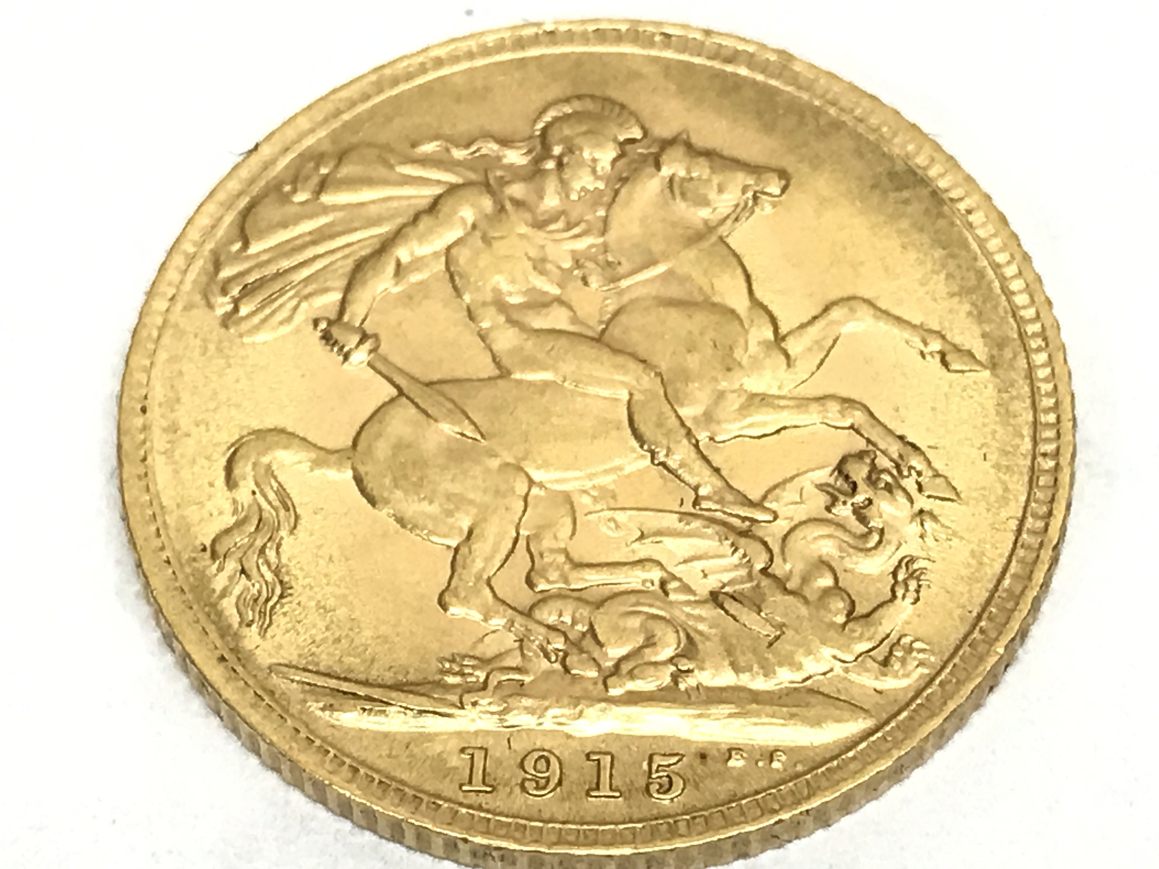 A gold 1915 full sovereign. Postage category A
