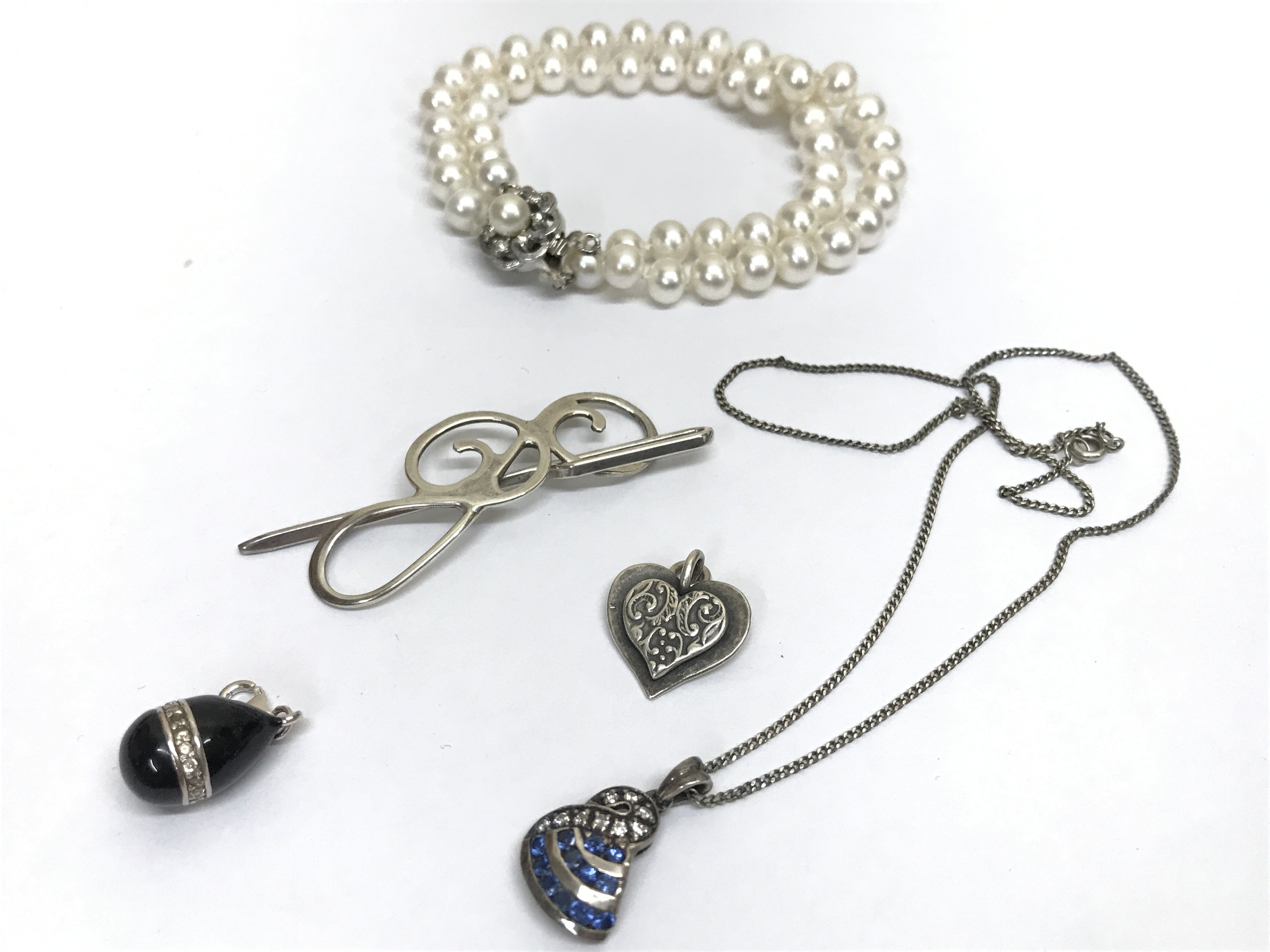 Silver stone set necklace , G.McKenzie black and stone set pendant, Shablool heart pendant, cloak pin and a cultured Pearl bracelet . Postage category A