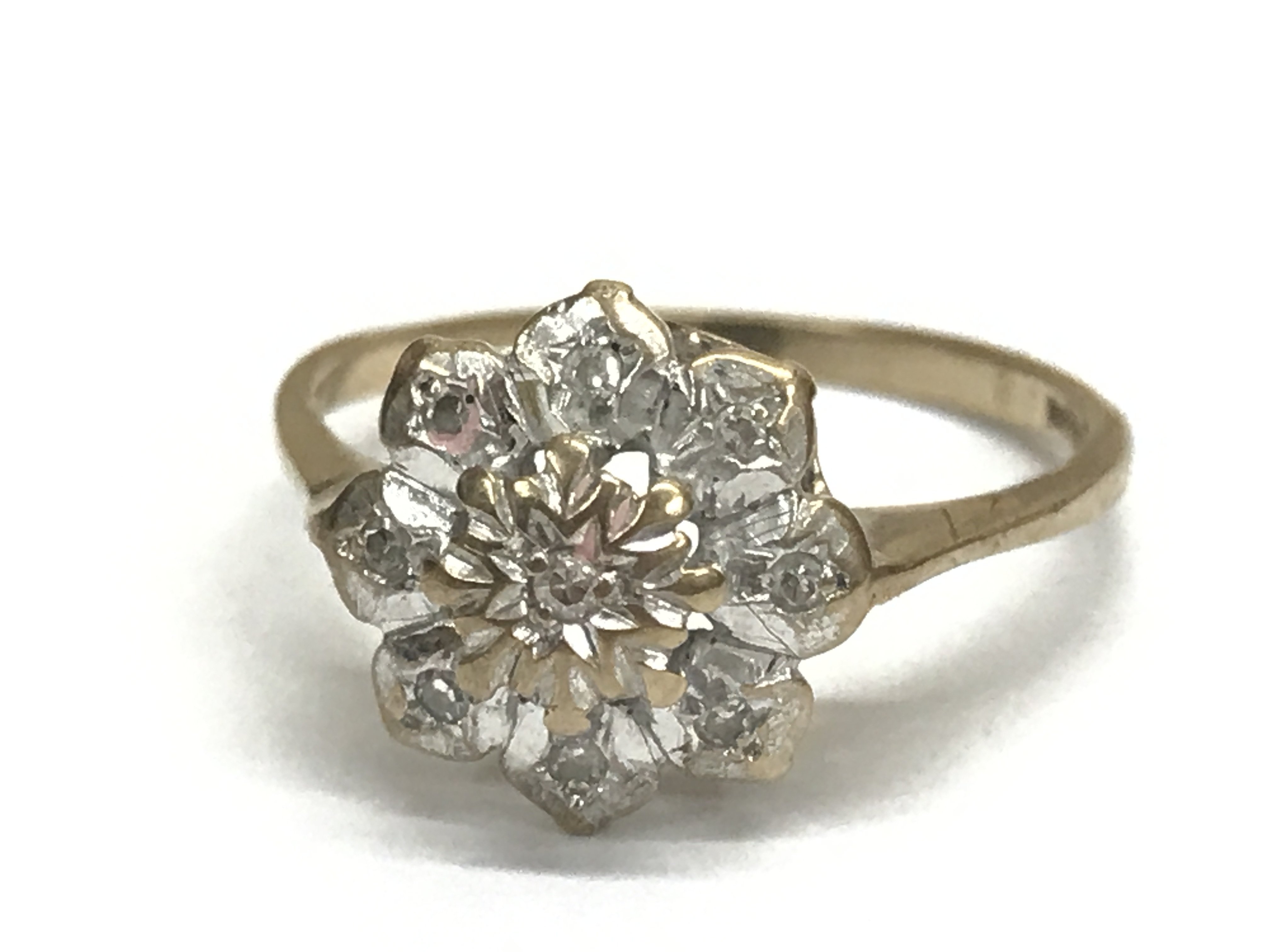 A 9ct gold diamond daisy shaped ring, N/O. Total weight 2g. Postage category A