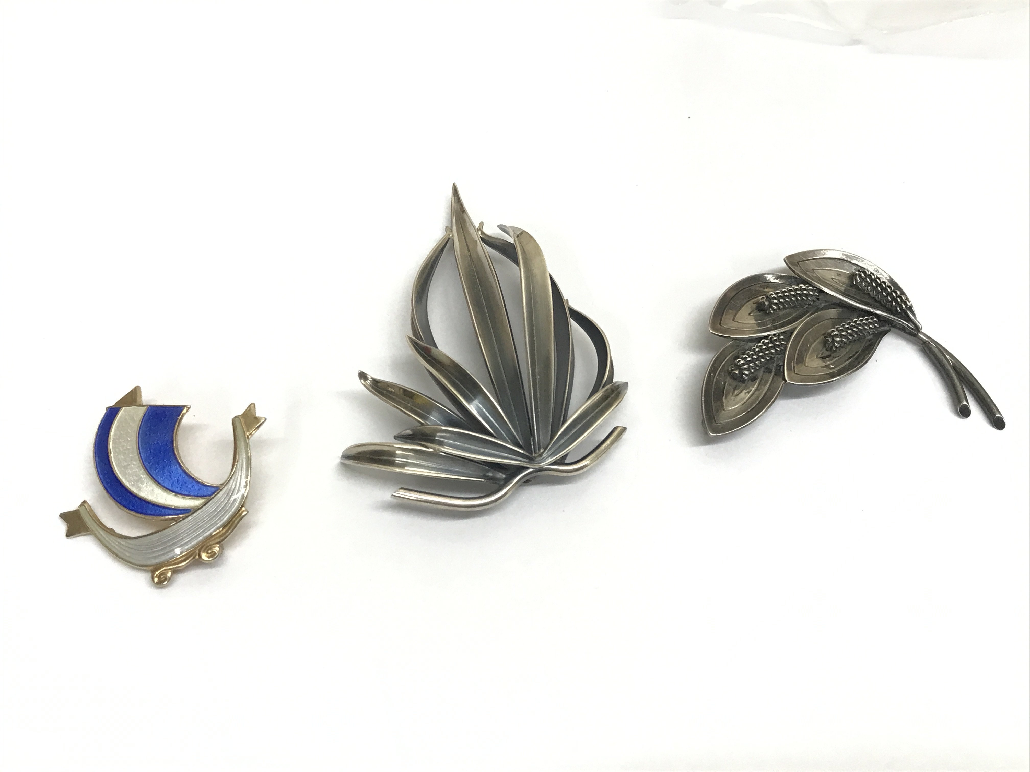 Anton Michelsen Rougie silver brooch, Aarre & Krogh Danish brooch and a silver enamel Viking boat brooch . Postage category B