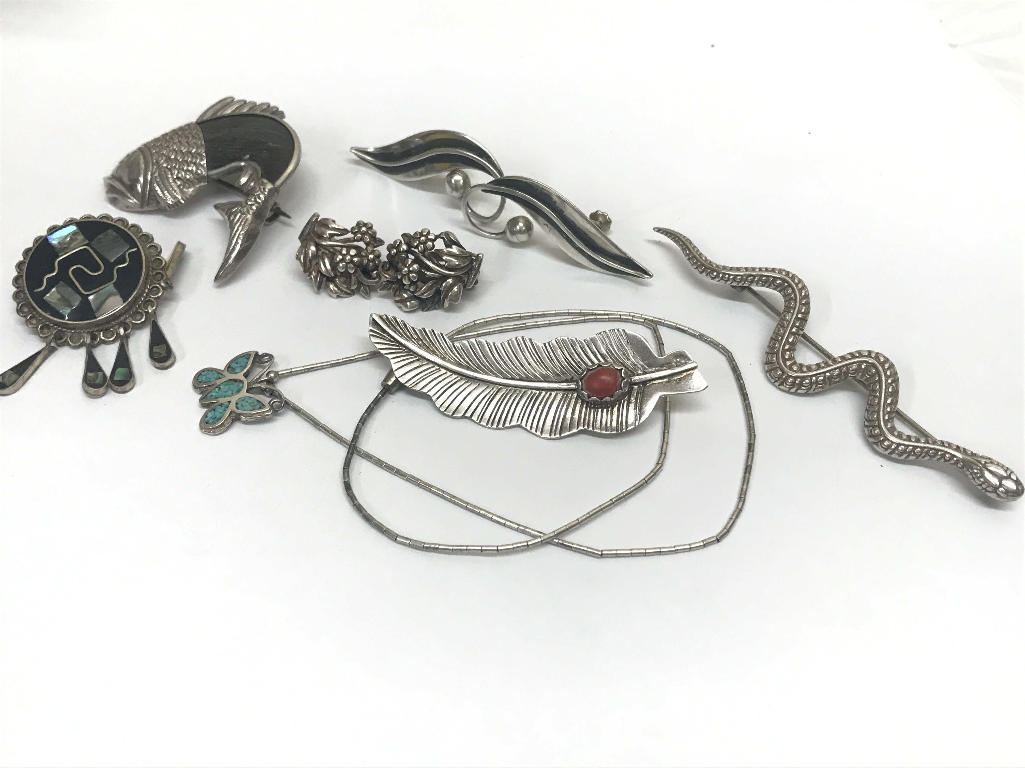 Silver jewellery including Native American and Mexican brooches , two pairs of earrings and pendant , snake brooch, fish brooch, leaf brooch