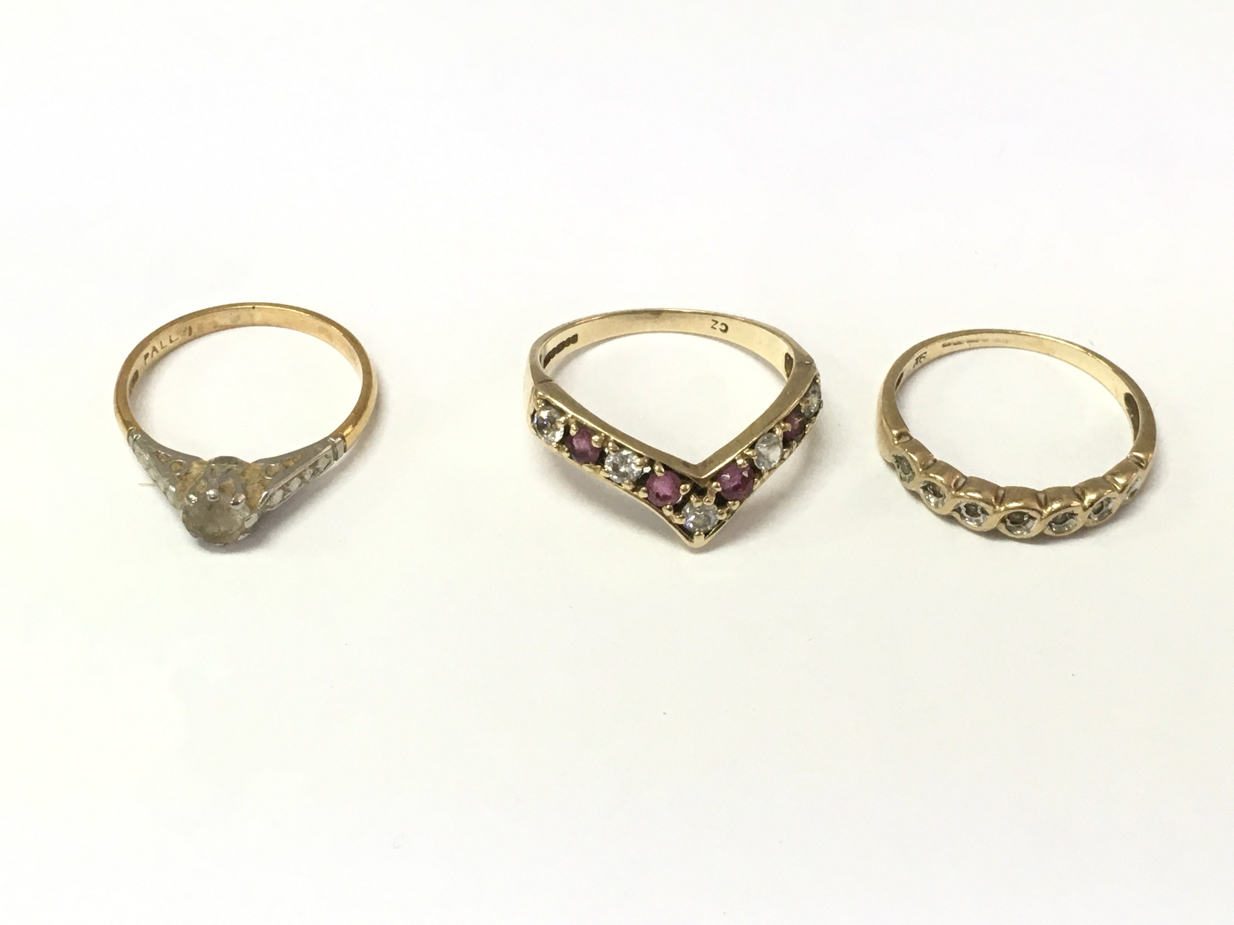 An 18ct gold and platinum stone set ring 1.83g and two 9ct gold stone set rings 3.49g Postage A