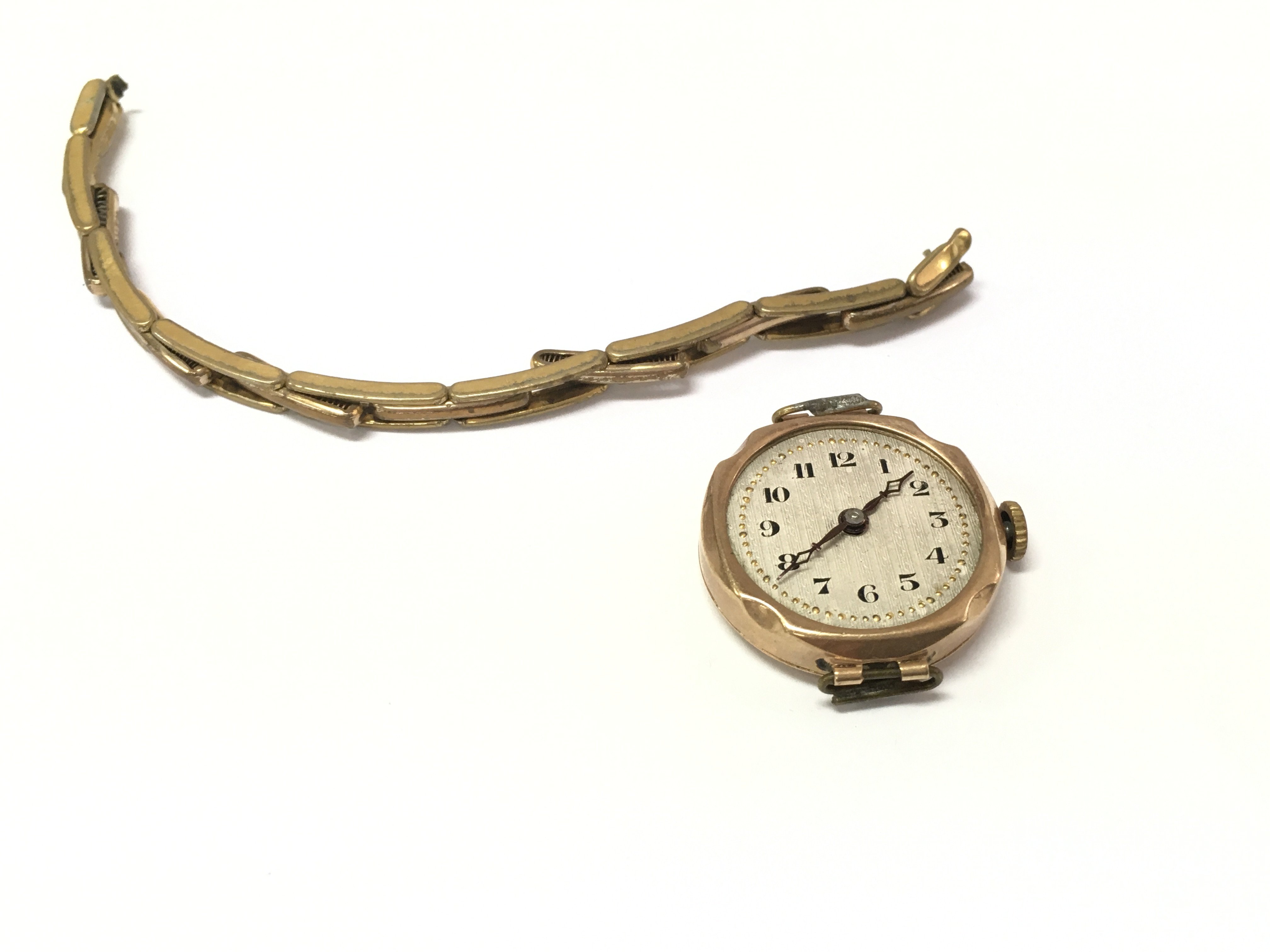 A 9ct gold cased watch with a rolled gold strap. Postage A