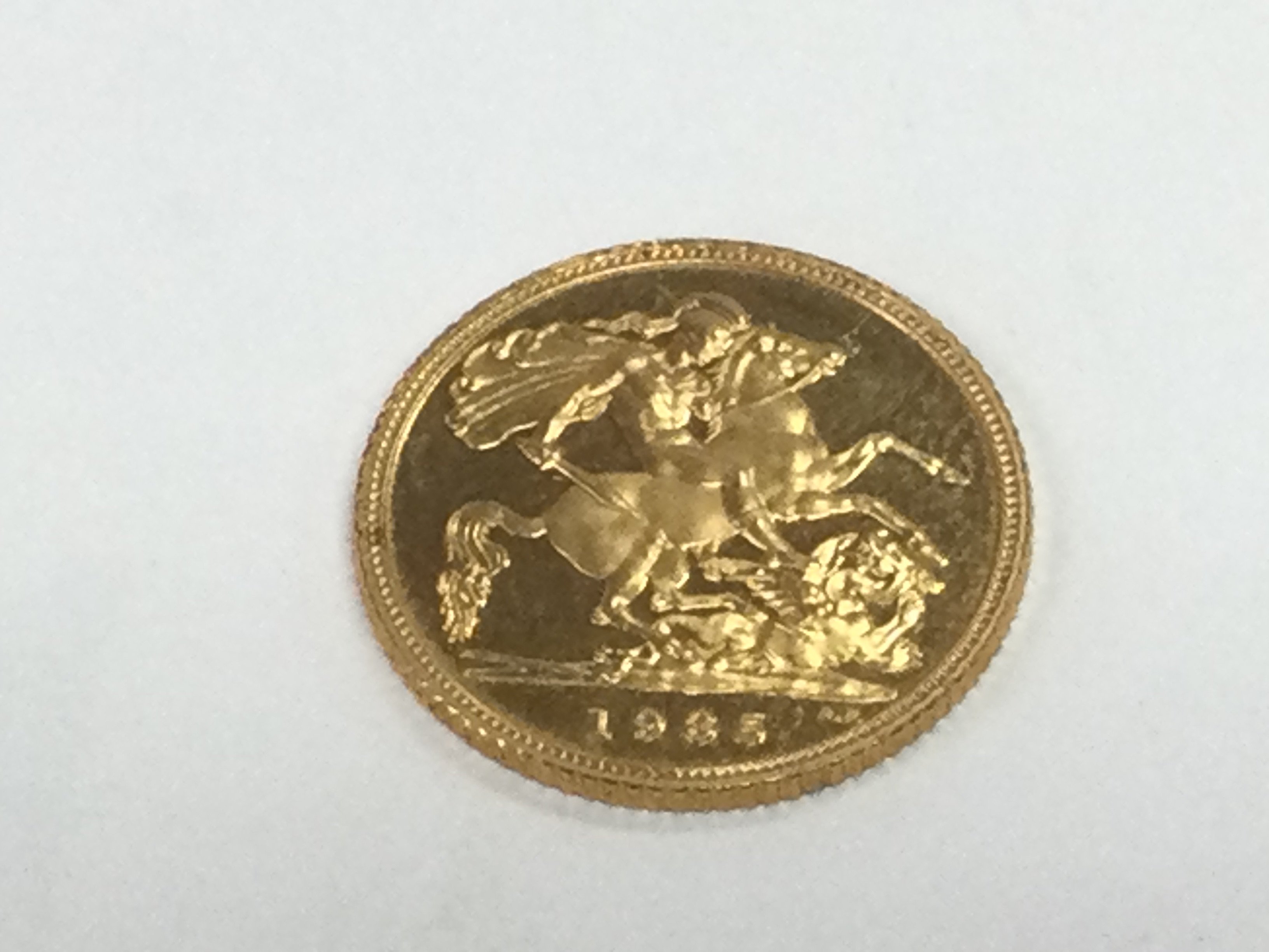 A 1985 gold 1/2 sovereign. Shipping category A.
