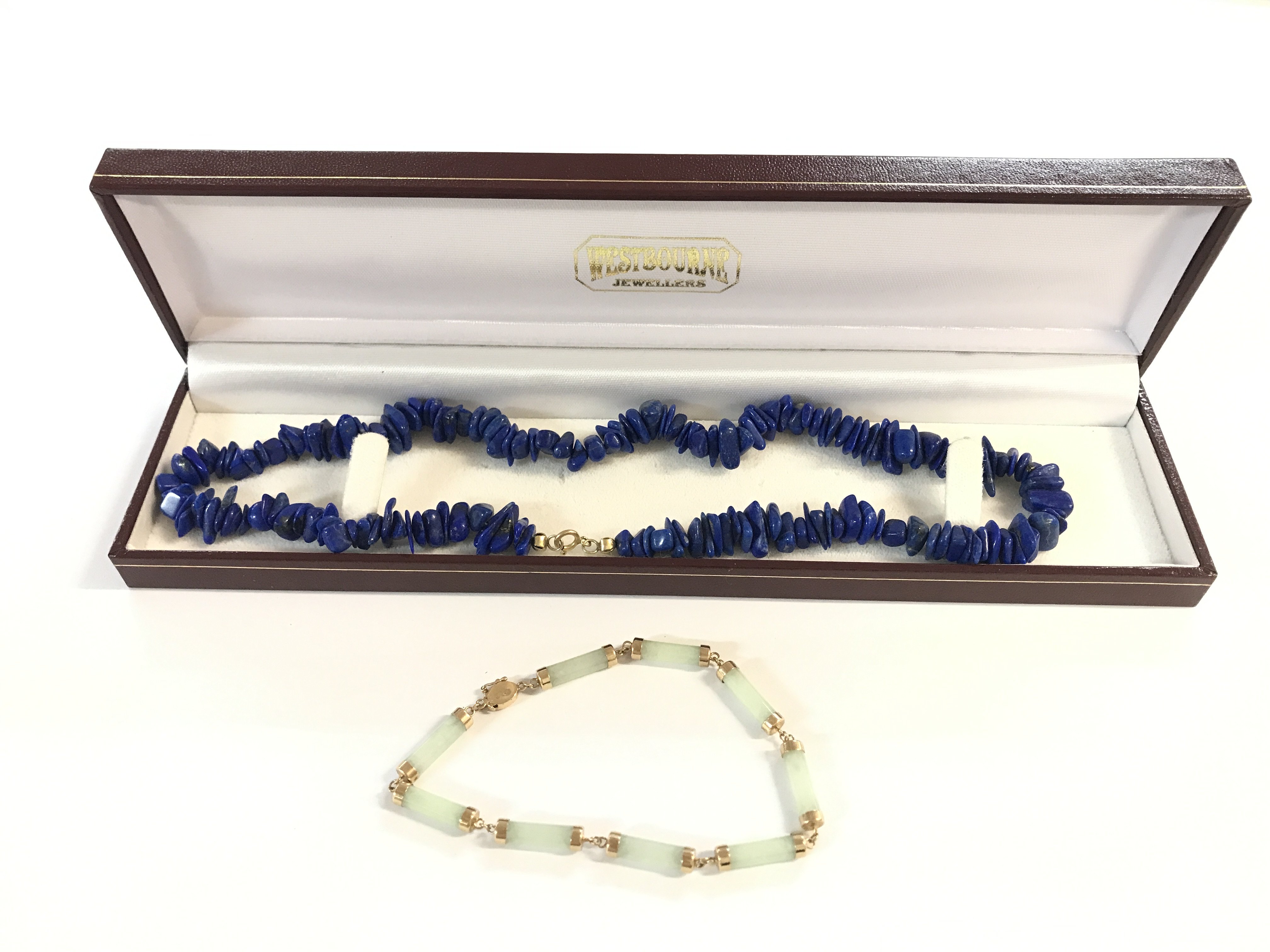 A boxed 9 karat gold jade bracelet and a lapis 9 karat gold necklace