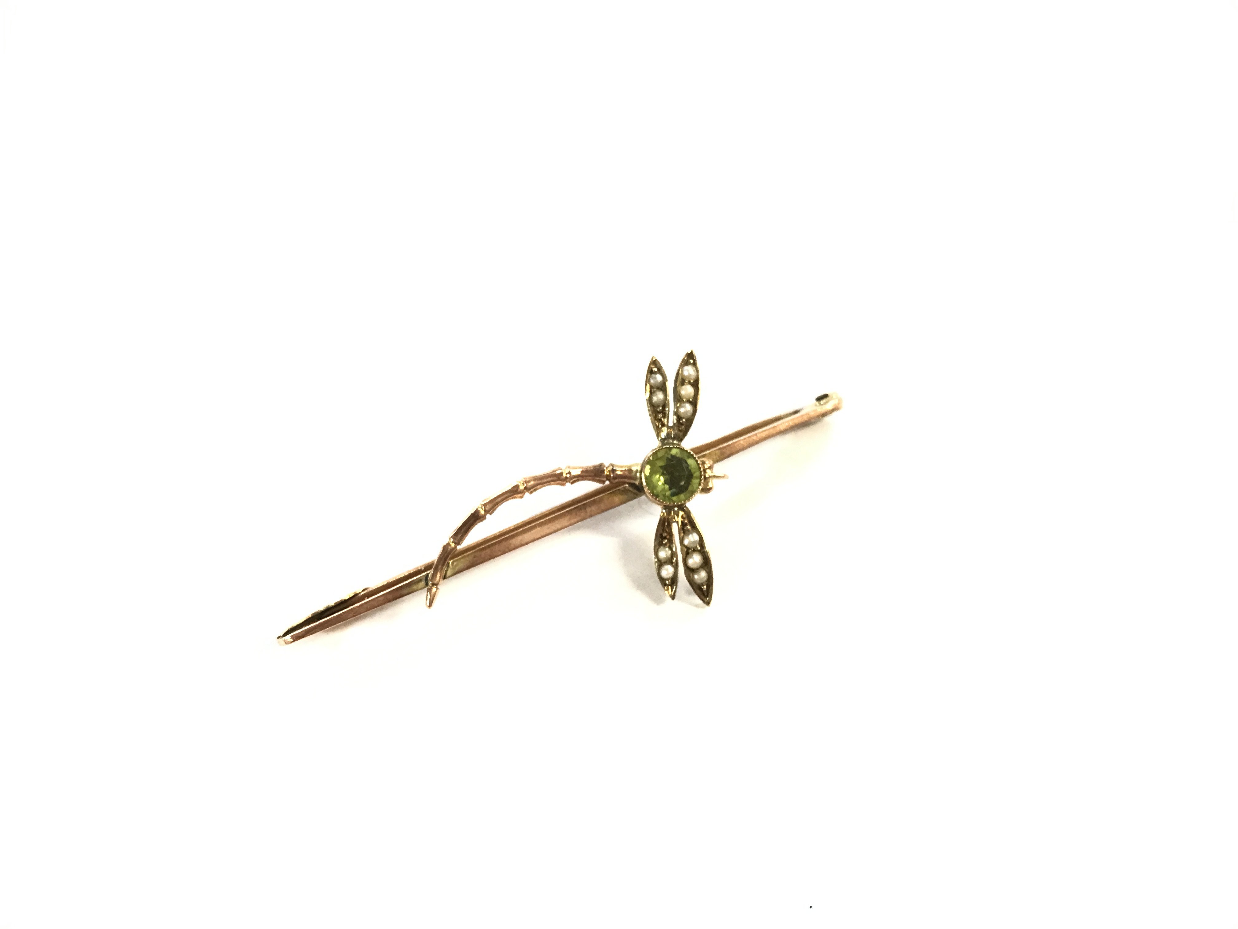 A 9 karat gold peridot and seed Pearl dragonfly broach.